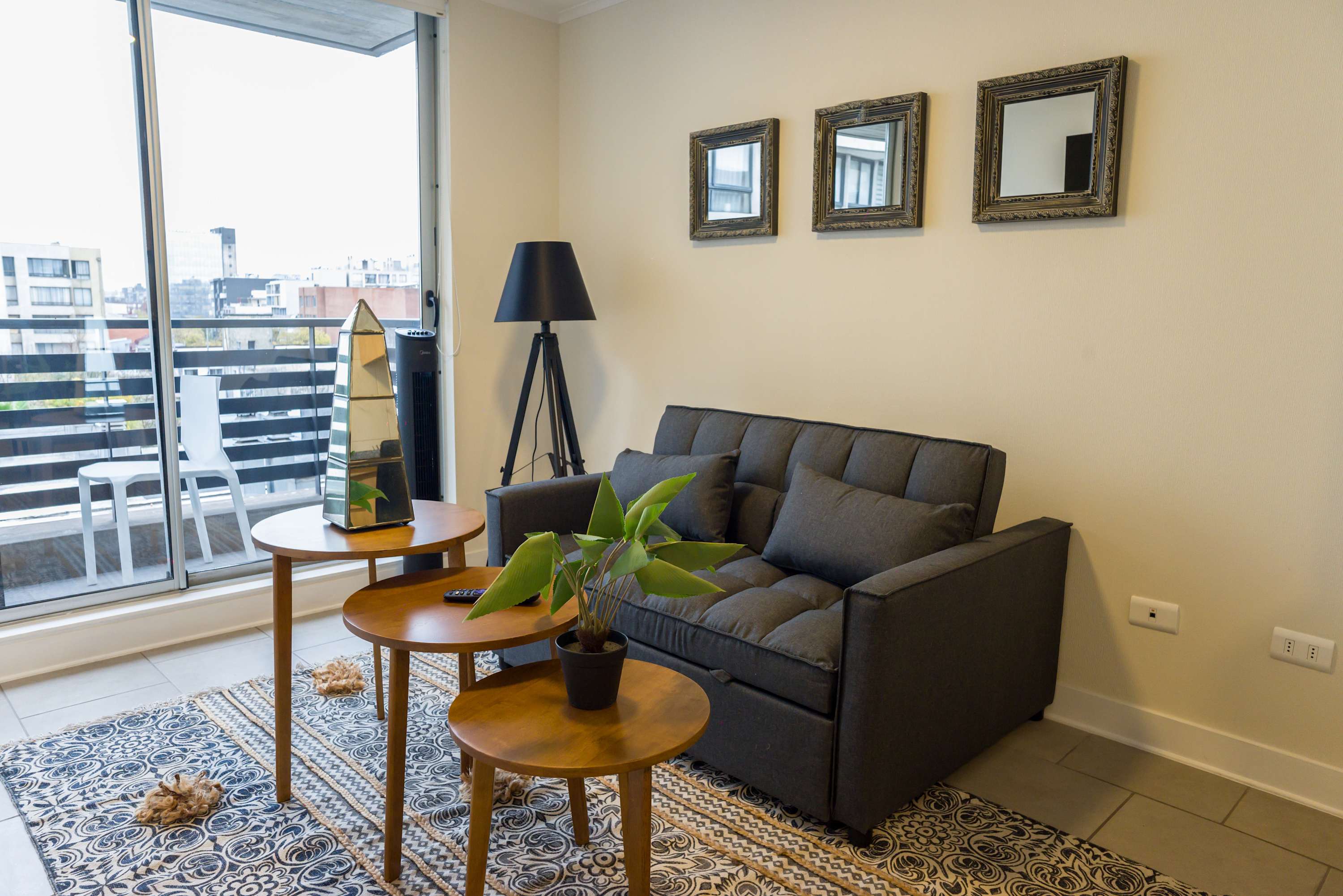 Cozy living space with city views, perfect for relaxation. Enjoy the stylish decor and natural light from the private balcony.