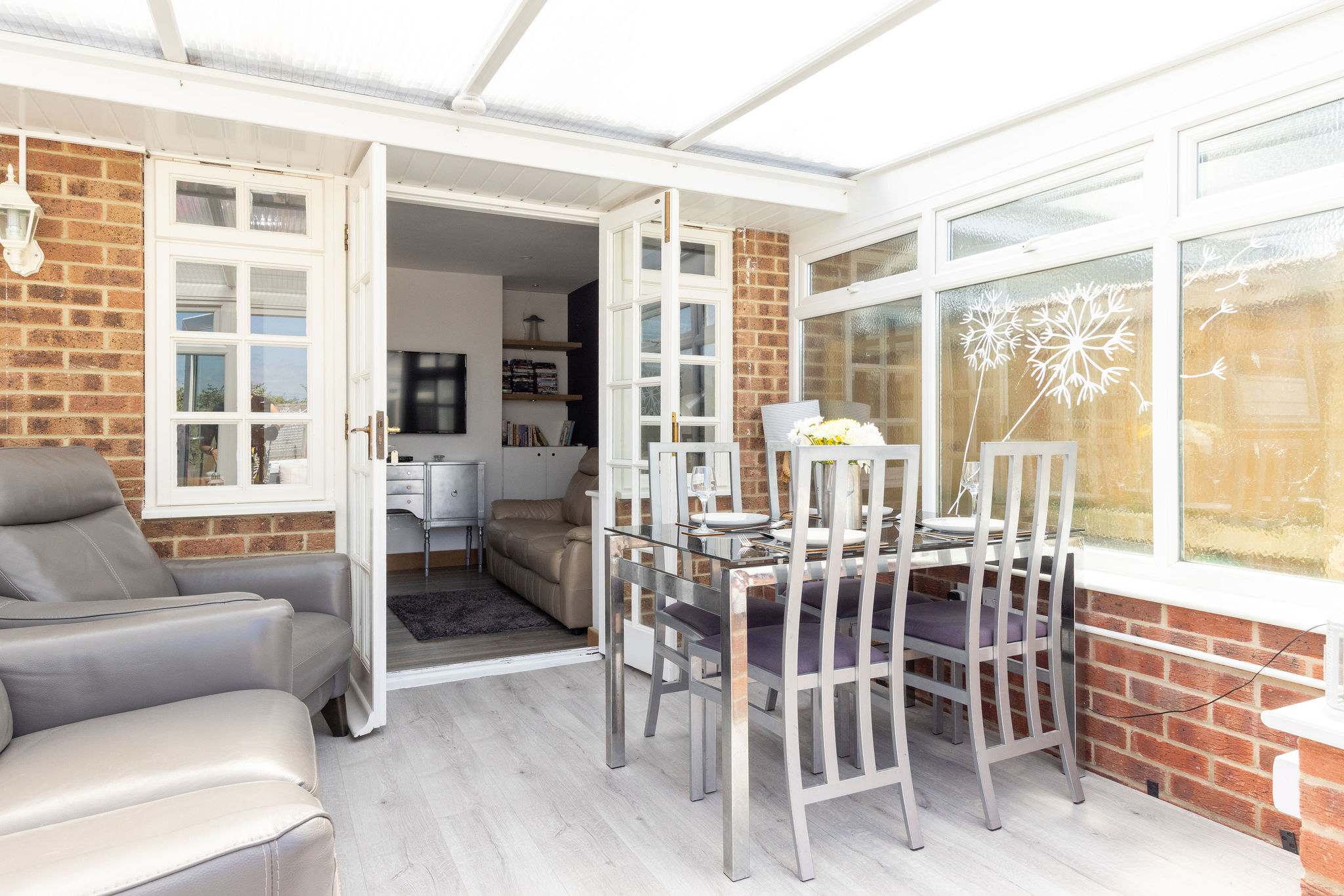 Dining space and recliners in the bright conservatory
