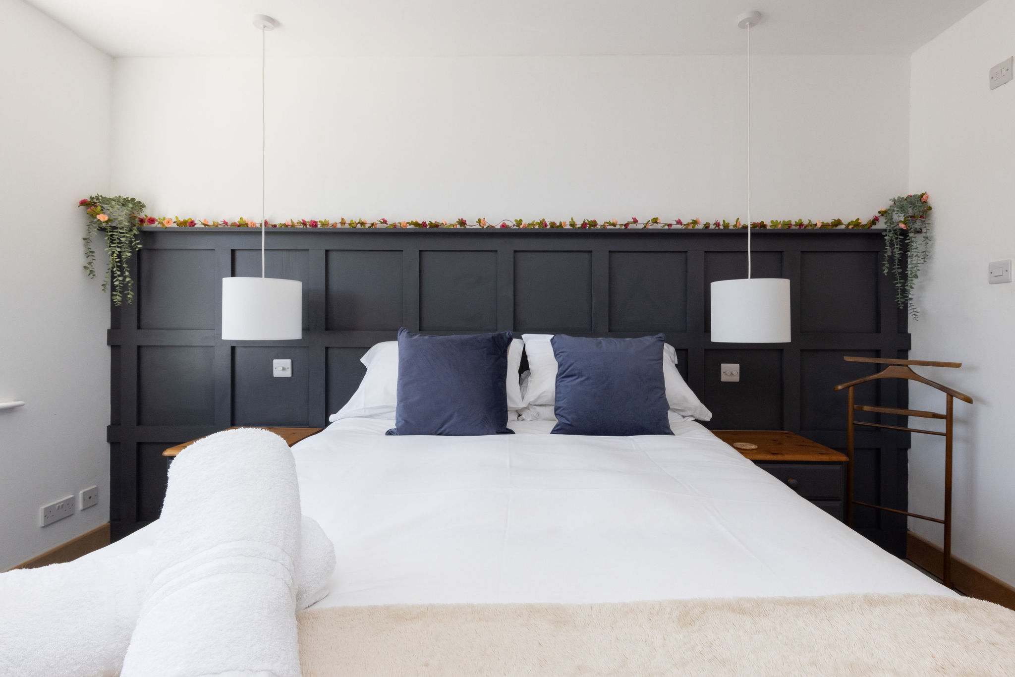 Bright king bedroom with plush bedding and storage