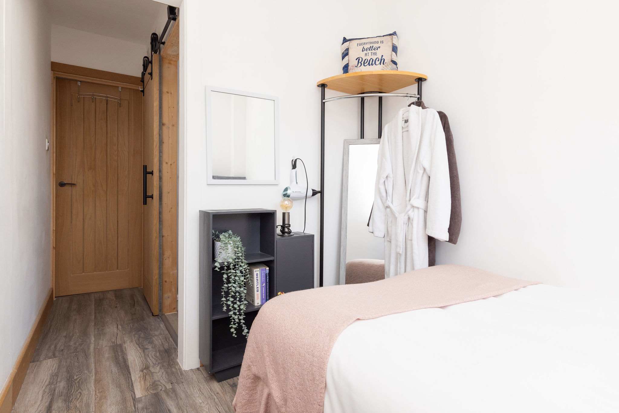 Compact bedroom with mirror and robe hooks