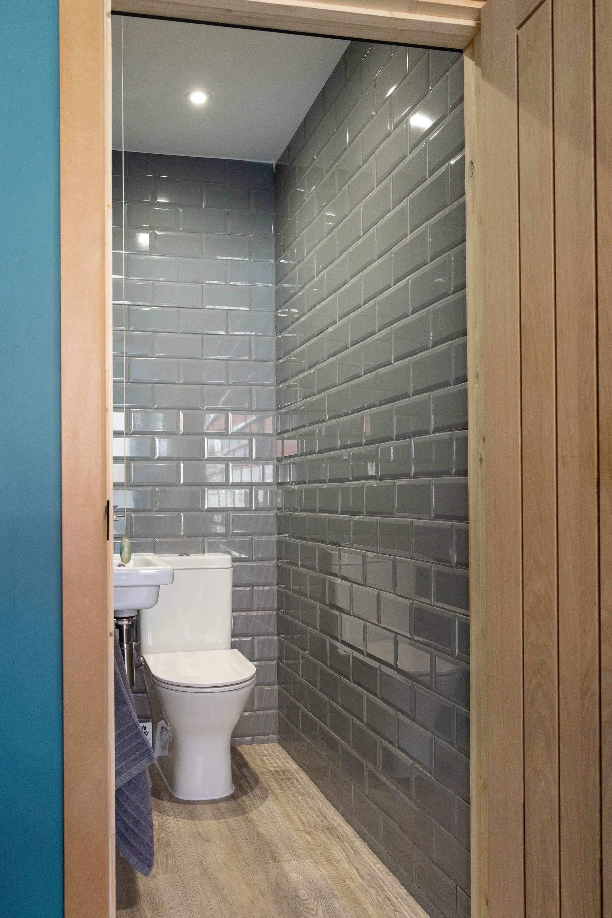 Stylish WC with glossy grey tiles