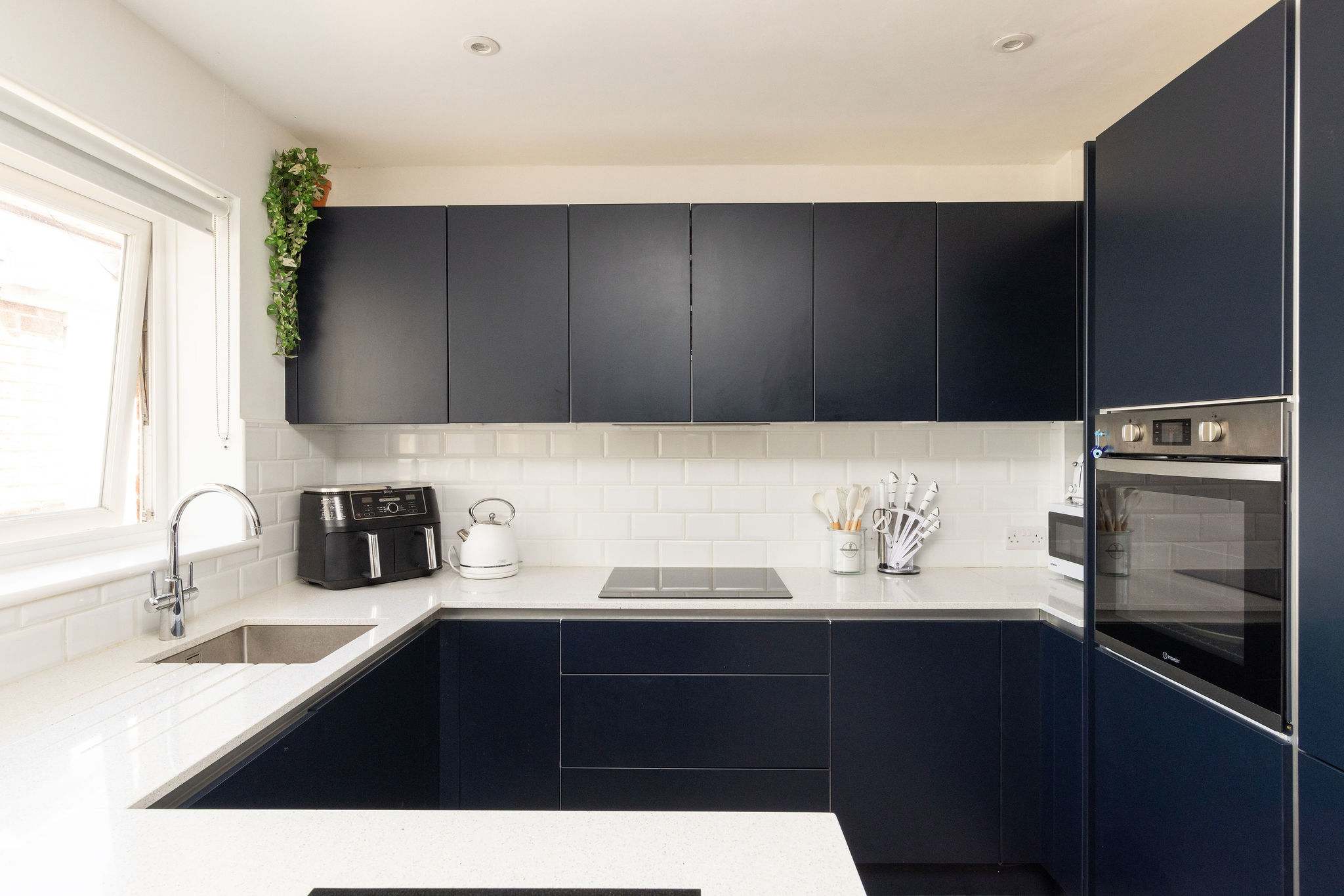 Sleek kitchen with air fryer and kettle