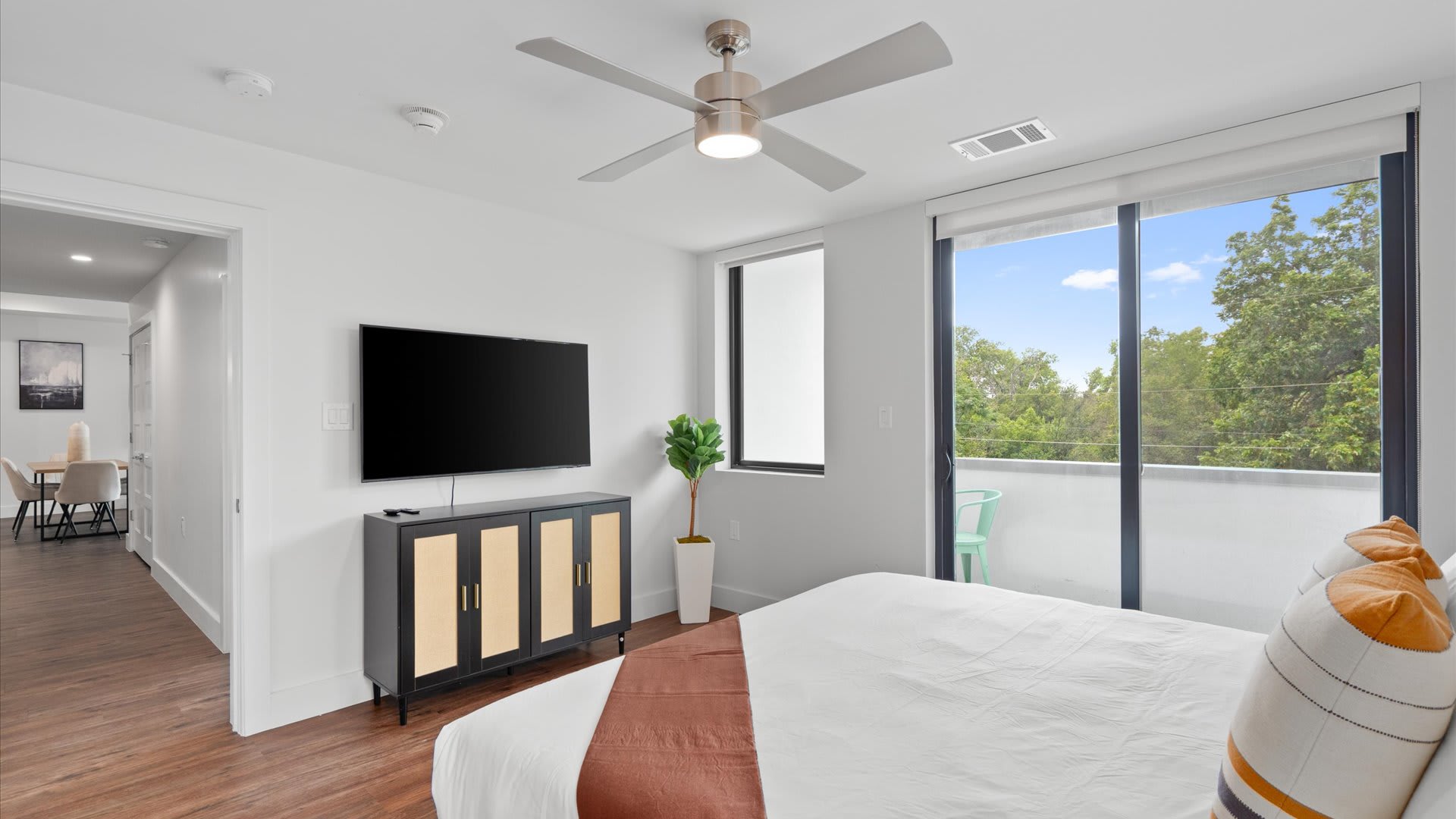 Queen bedroom with smart TV and patio access