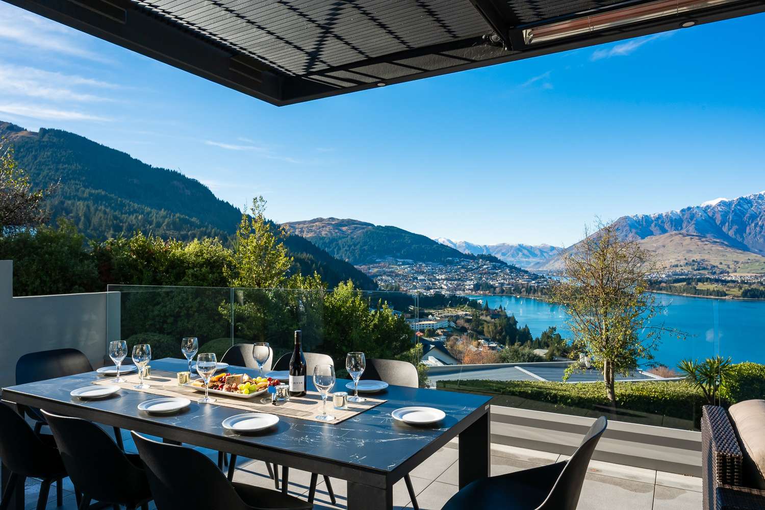 The outdoor seating area on the deck invites you to unwind with a glass of wine as the sun sets over Queenstown’s iconic lake. This peaceful retreat is perfect for memorable moments.