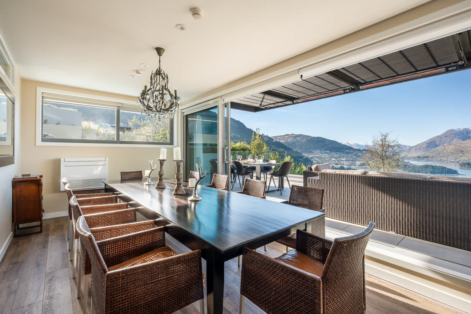 Share delicious home-cooked meals in a stylish space filled with natural light. The dining room flows seamlessly into the living area, ideal for entertaining during your Queenstown stay.