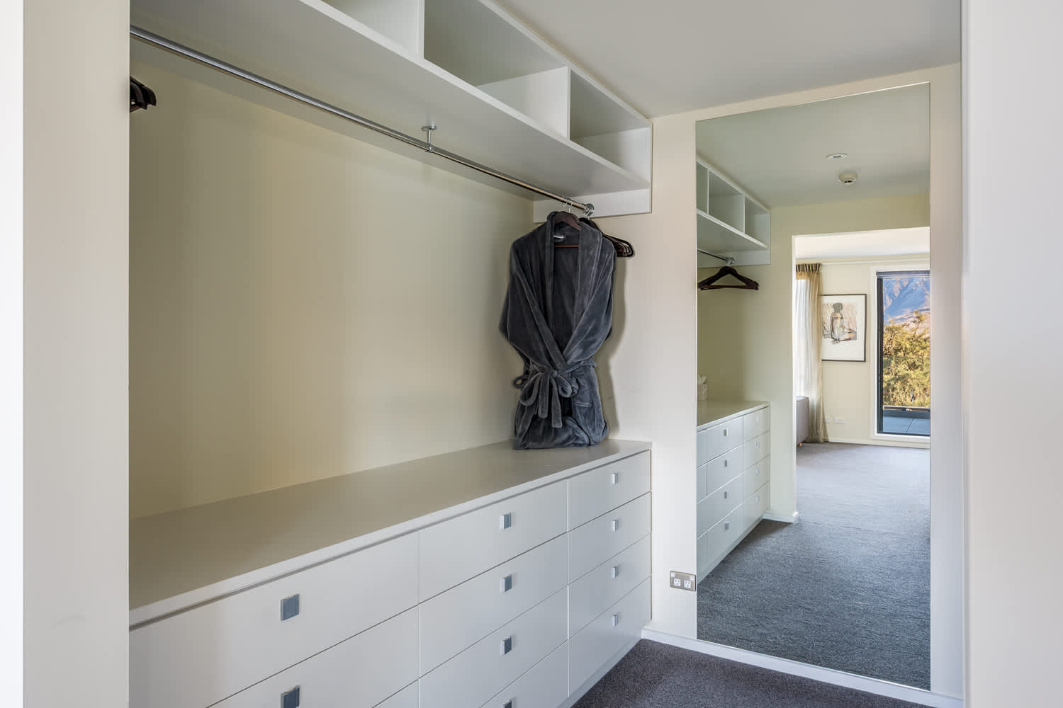 The spacious walk-in wardrobe offers ample room to organize your clothing and accessories with ease. It adds a touch of luxury and convenience to your Queenstown stay.