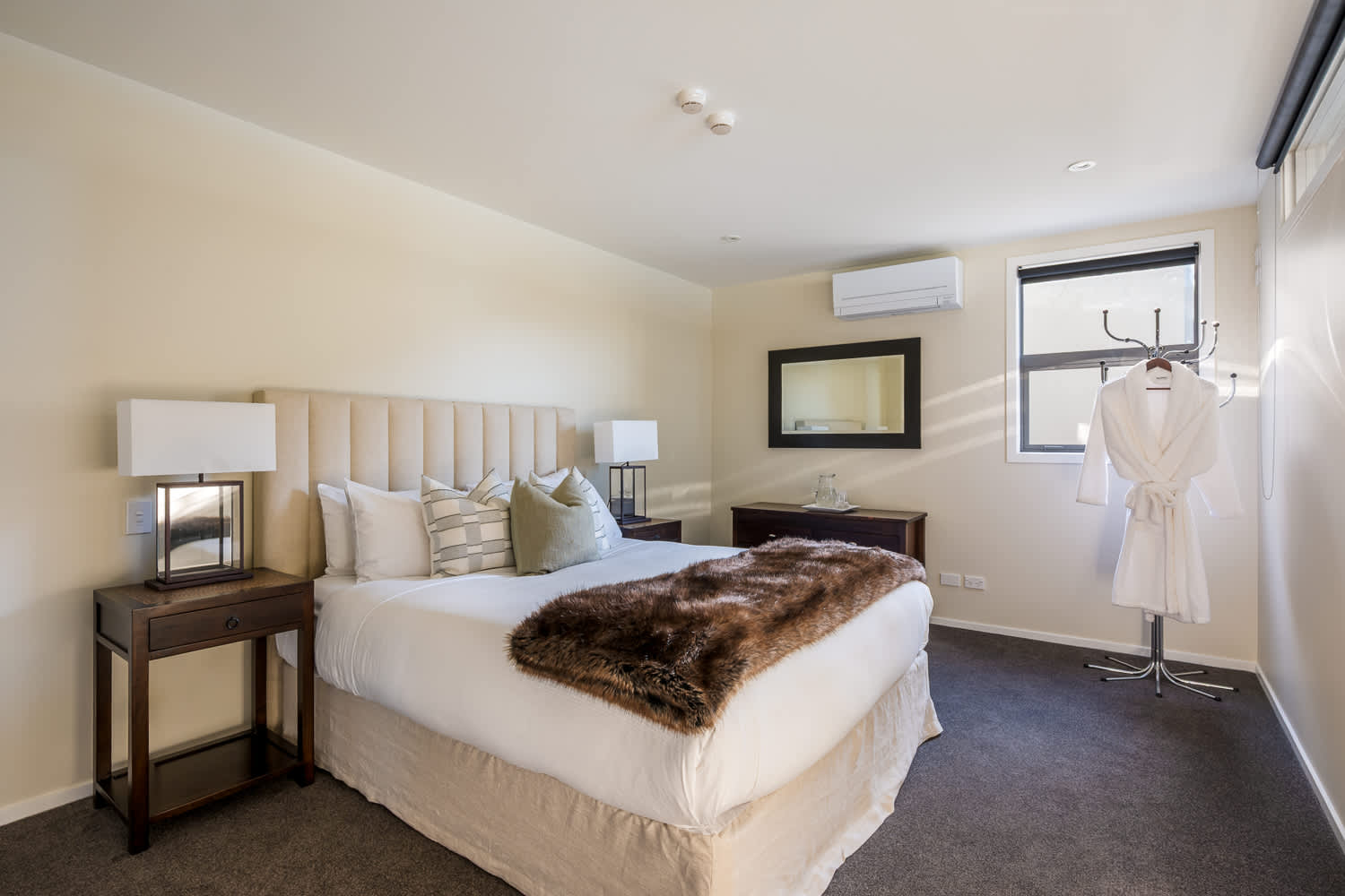 The cozy third bedroom offers a comfortable queen-size bed with soft linens, perfect for restful nights. It’s a peaceful retreat with stylish décor and plenty of natural light.