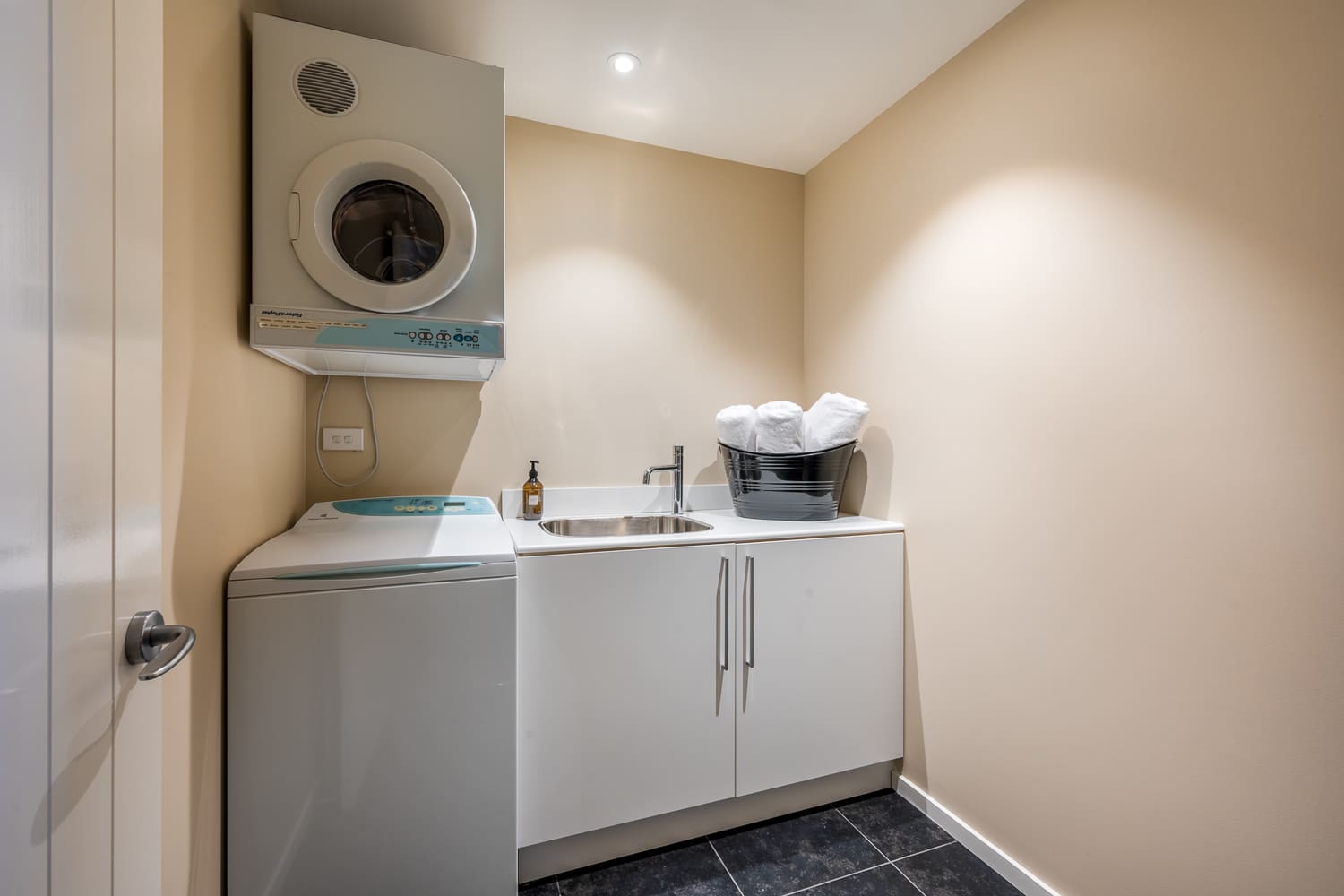The well-equipped laundry room features a washer and dryer for your convenience during longer stays. Keep your clothes fresh and ready while enjoying your Queenstown adventure.