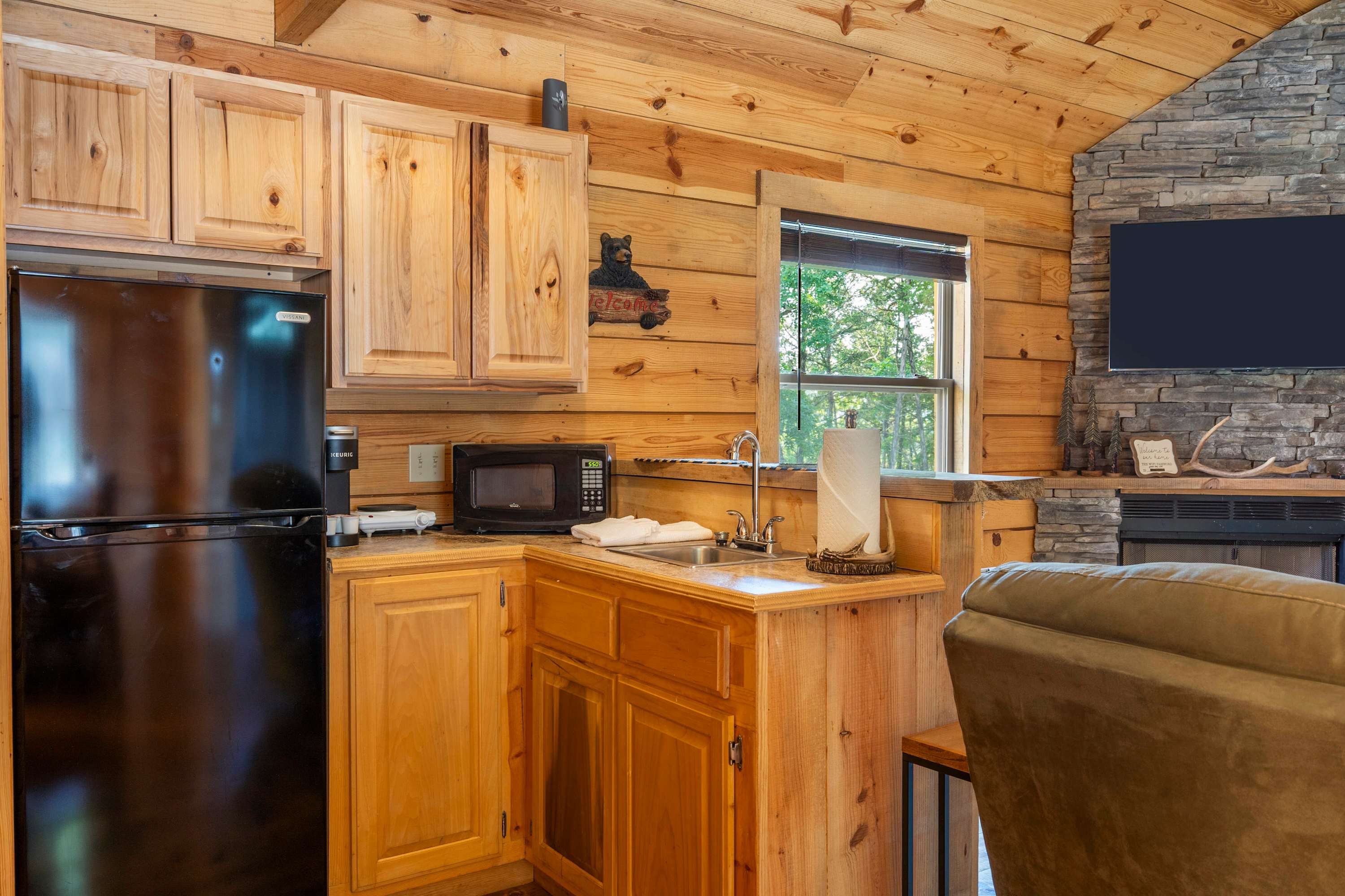 The open kitchen area offers ample storage & amenities for a great stay