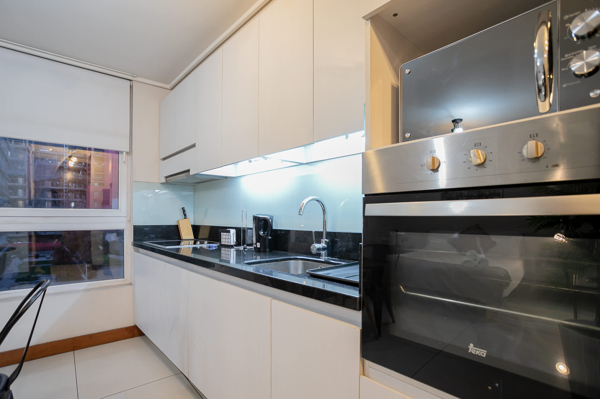 Sleek and modern kitchen with ample natural light, perfect for culinary adventures in the heart of the city.
