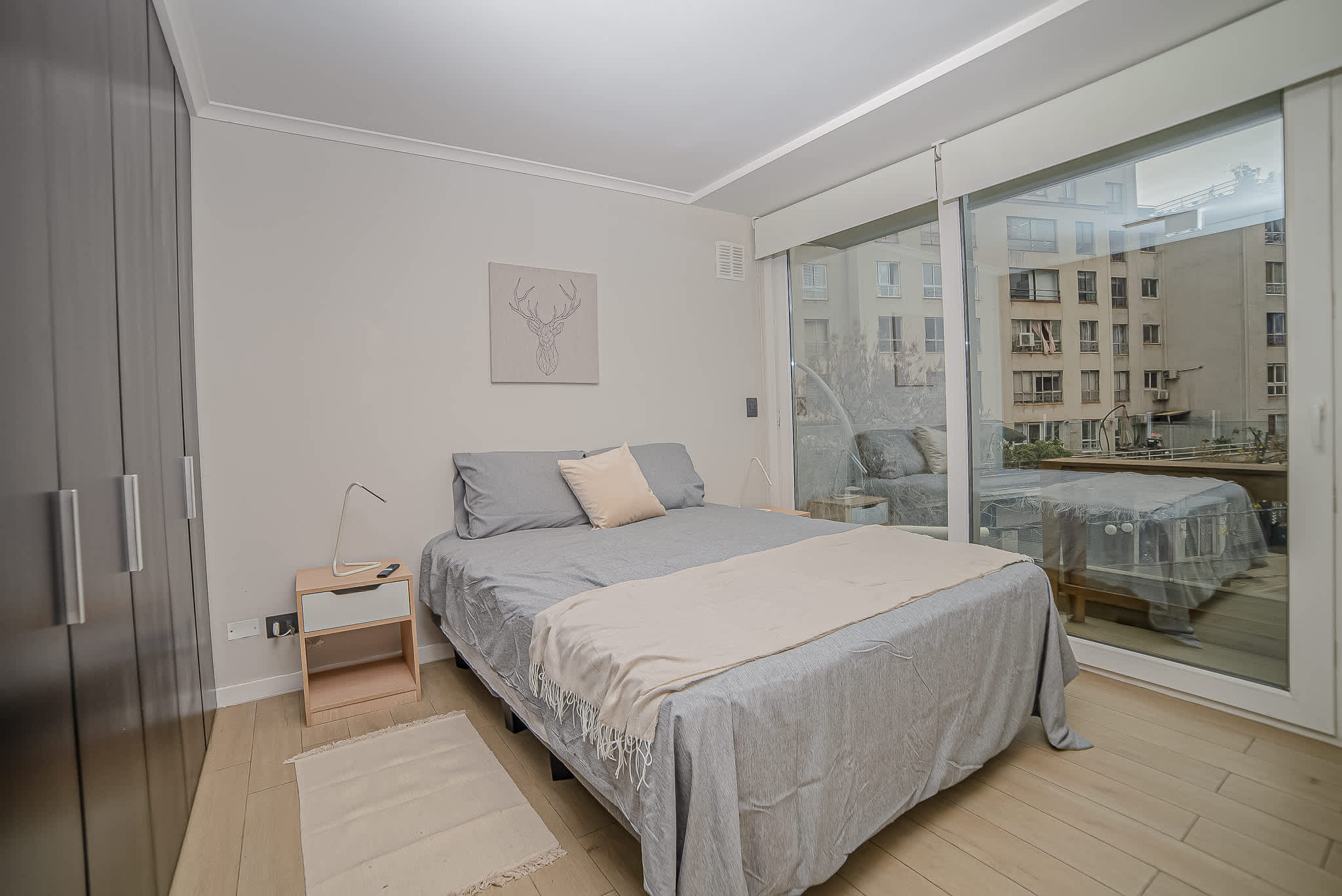 Relax in this cozy bedroom with stunning city views and modern amenities, perfect for a restful stay.