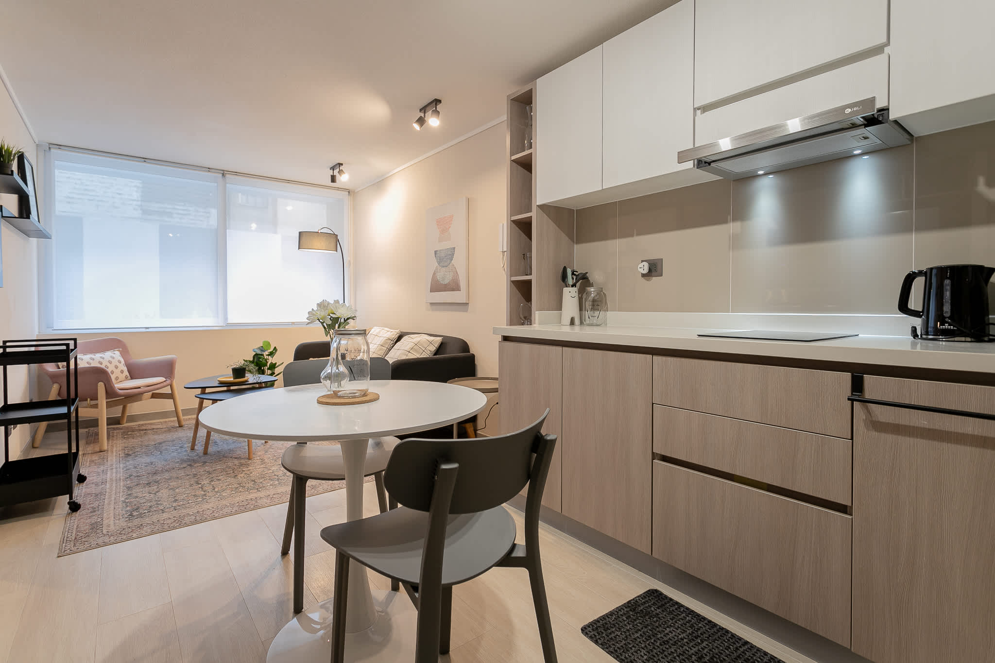 Modern studio with a stylish kitchen and cozy seating area, perfect for a relaxing stay in the heart of the city.