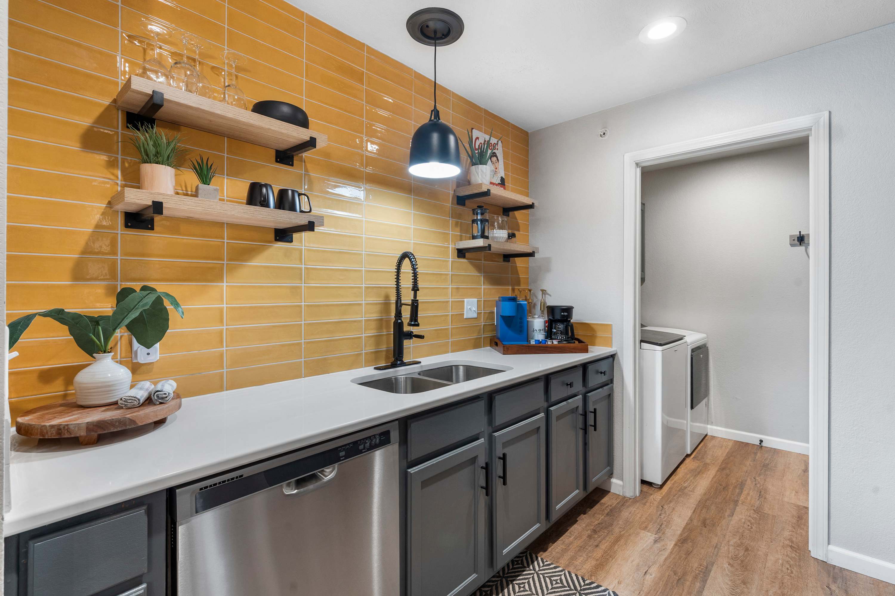 The sleek, open kitchen offers ample space & every home comfort