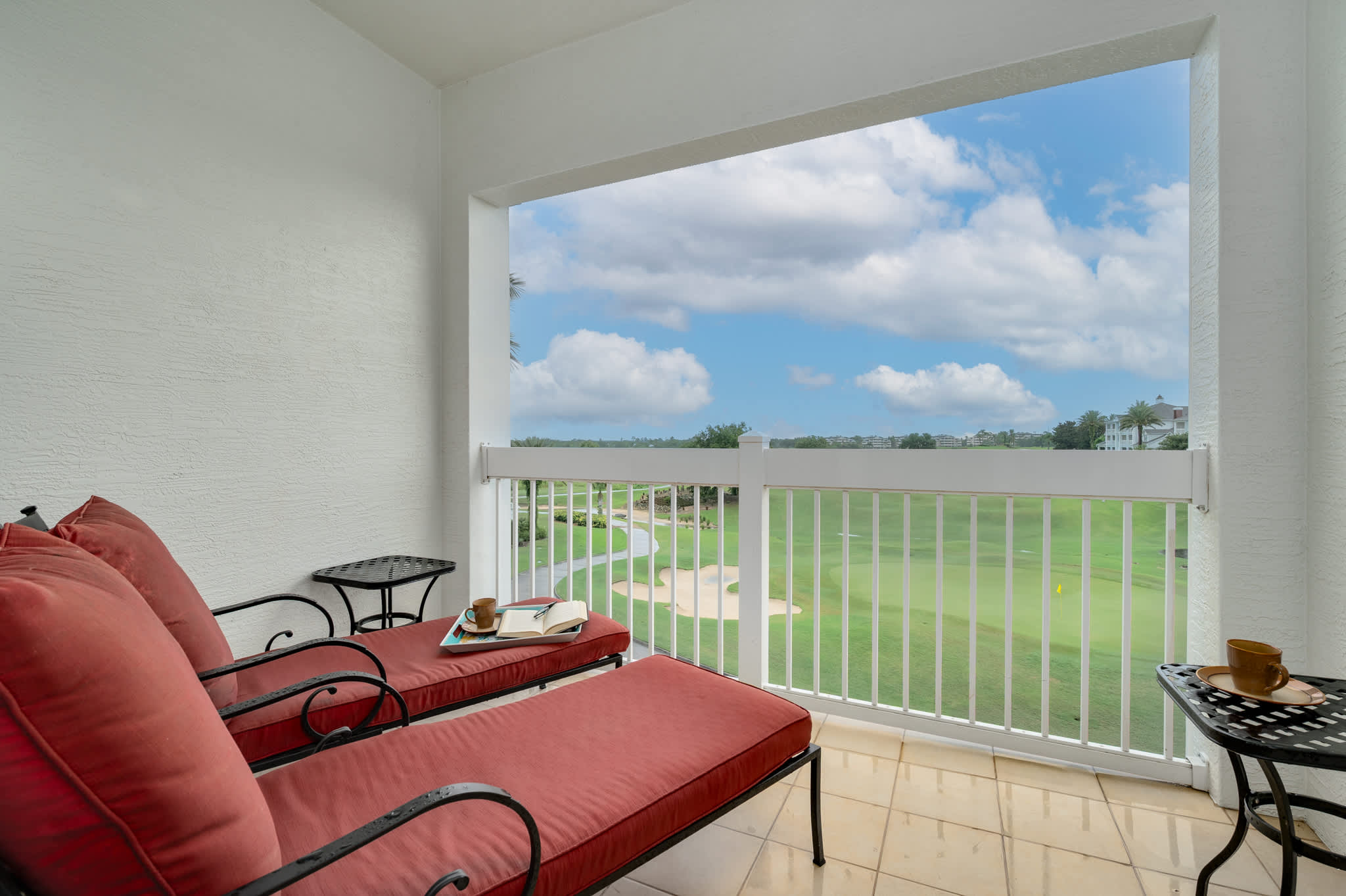 Soak up the sun and enjoy the stunning golf course views from your private balcony, featuring comfortable lounge seating.