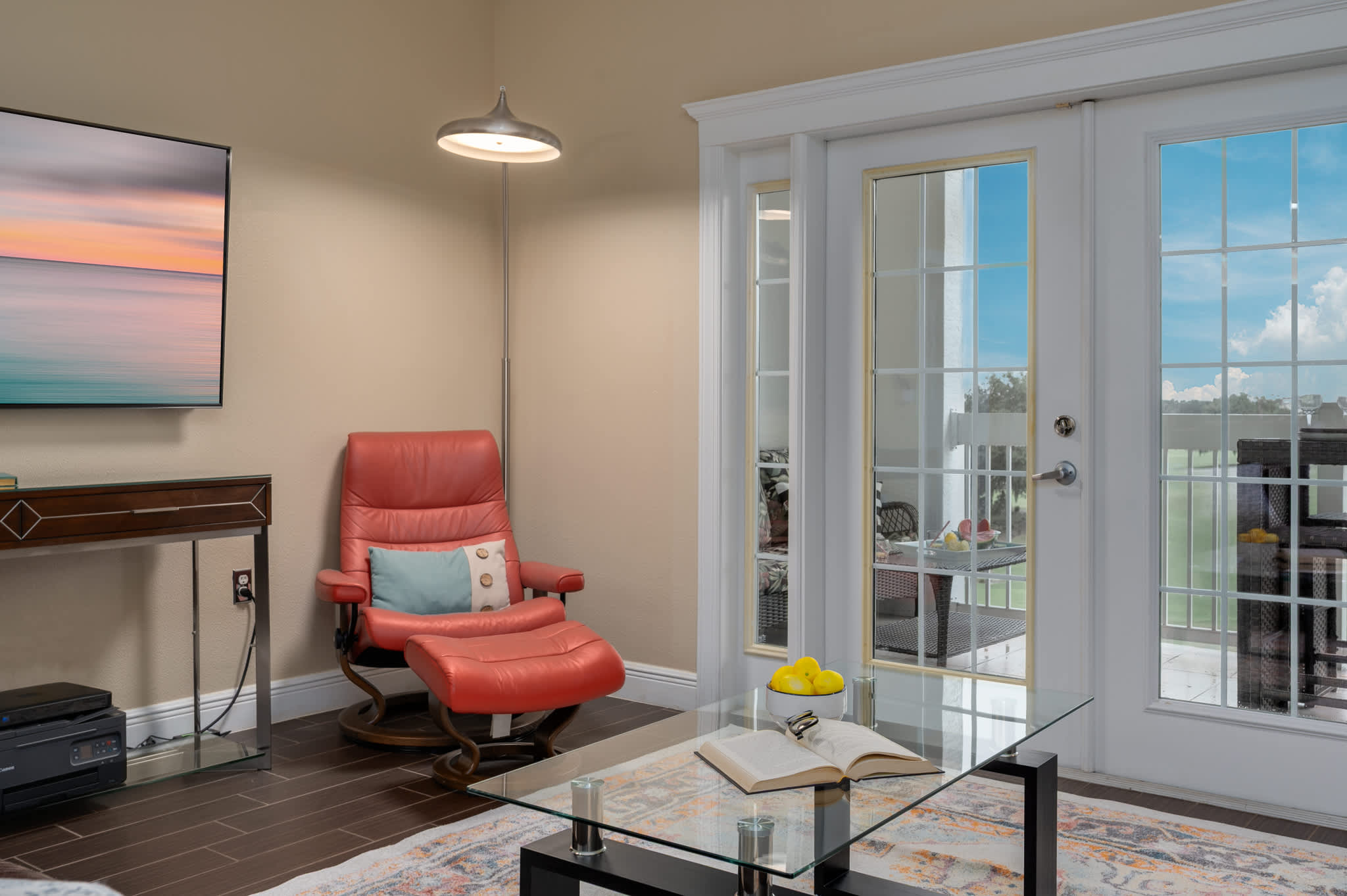 Relax in comfort in this inviting living room, seamlessly flowing into the kitchen area for an open and connected feel