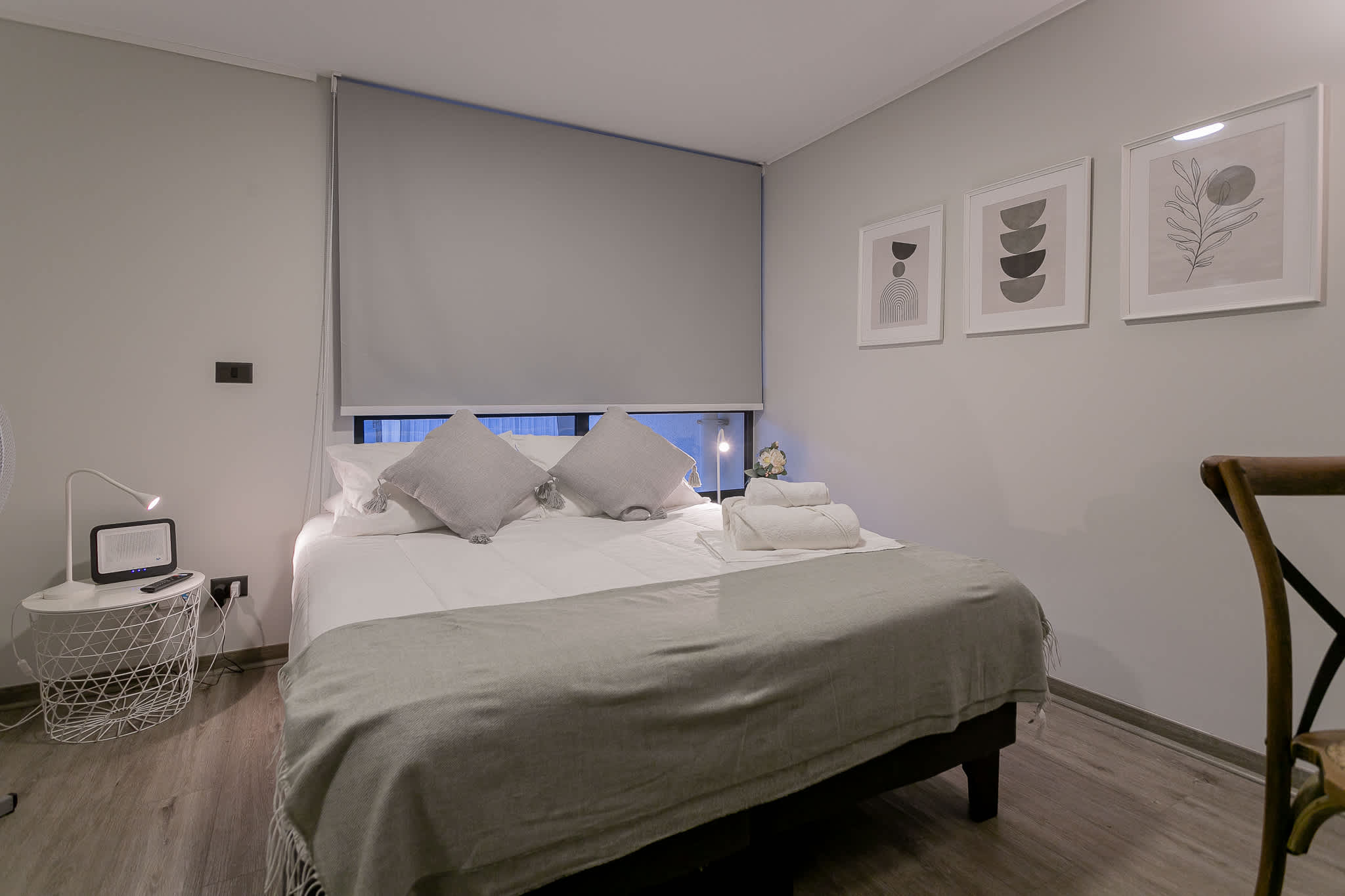 Relax in this stylish and serene bedroom, perfect for unwinding after a day exploring the city.