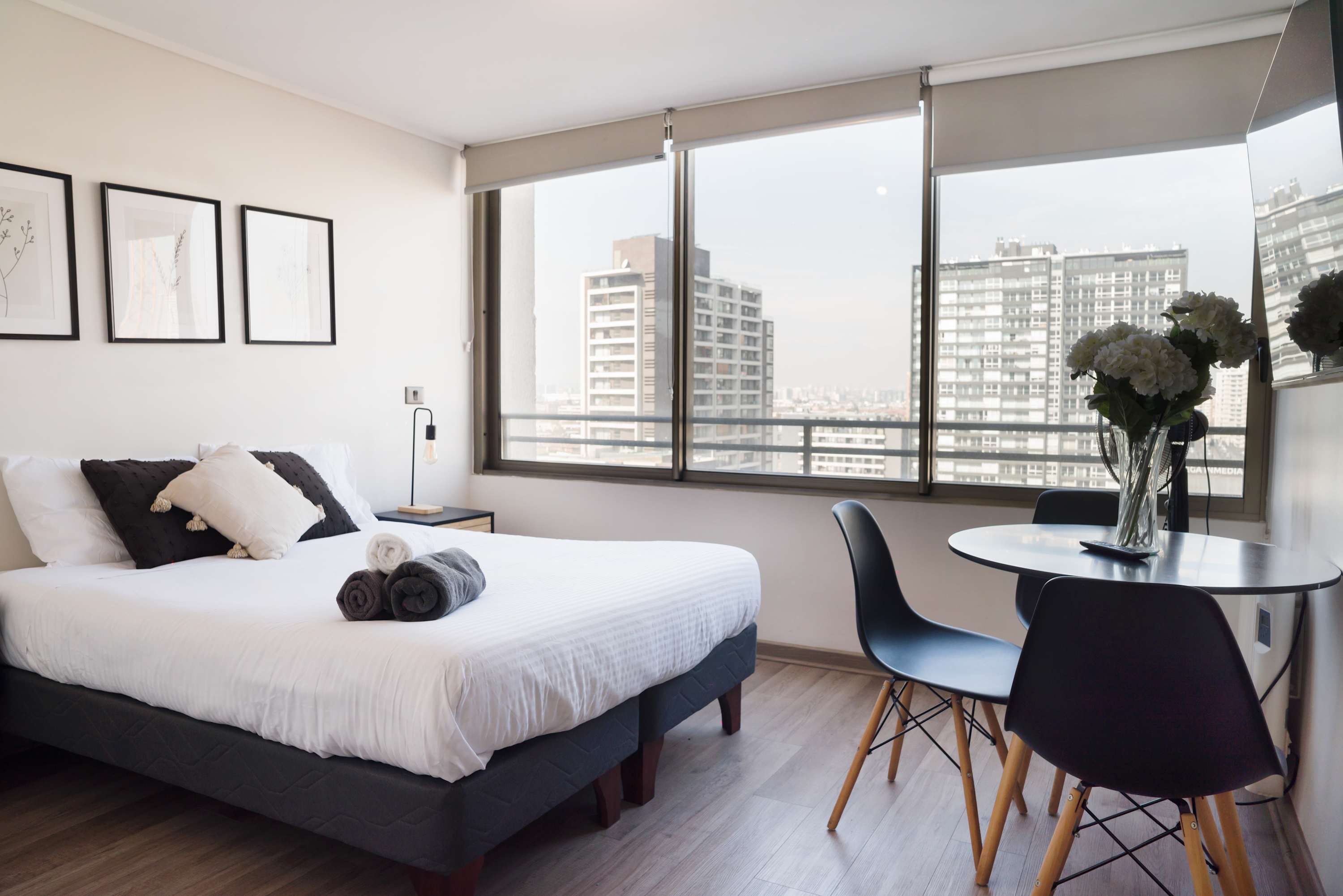 Enjoy stunning city views from this cozy studio apartment, featuring a comfy bed and a charming dining nook.