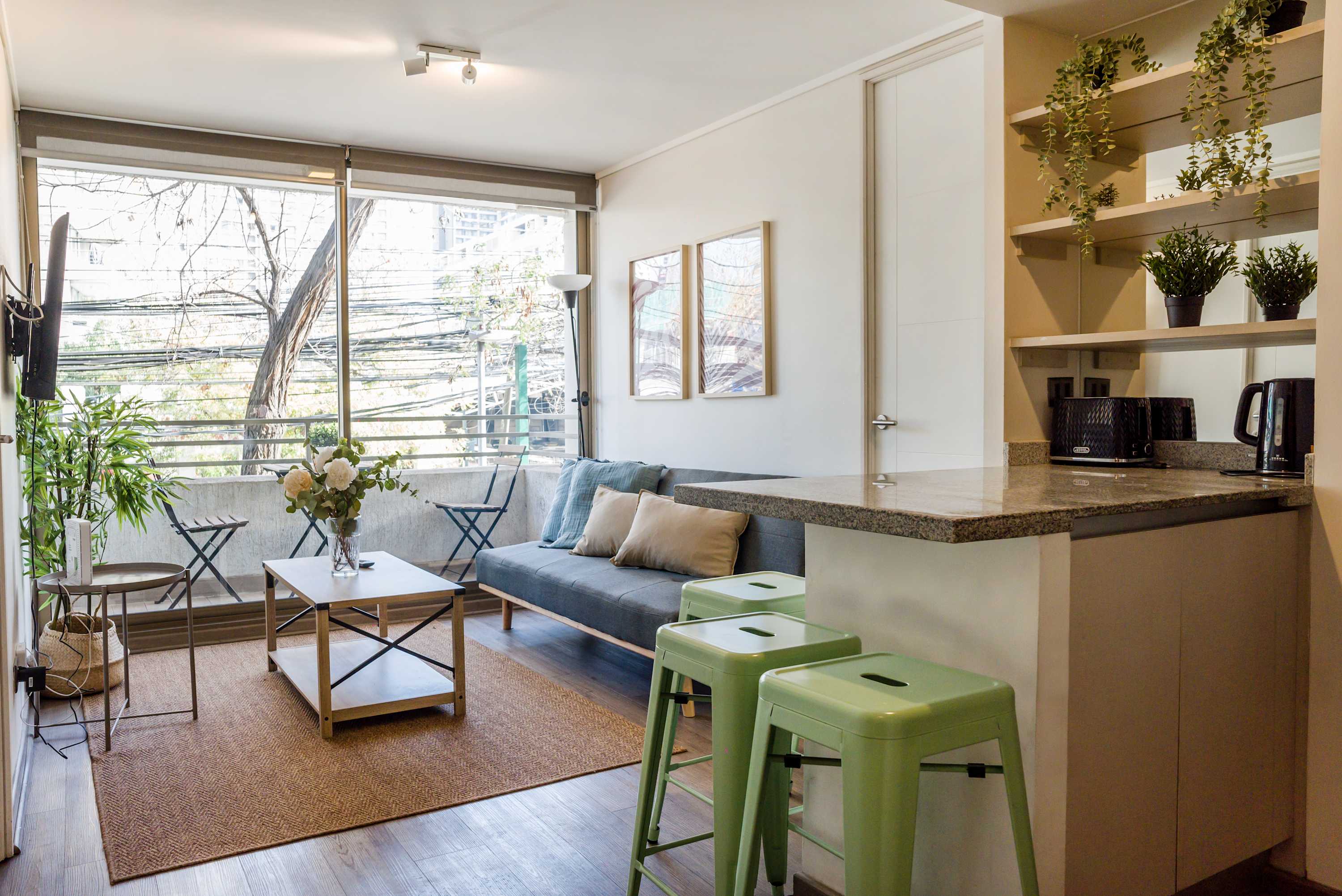 Cozy and bright living space with modern decor and a view, perfect for relaxing after exploring the city.