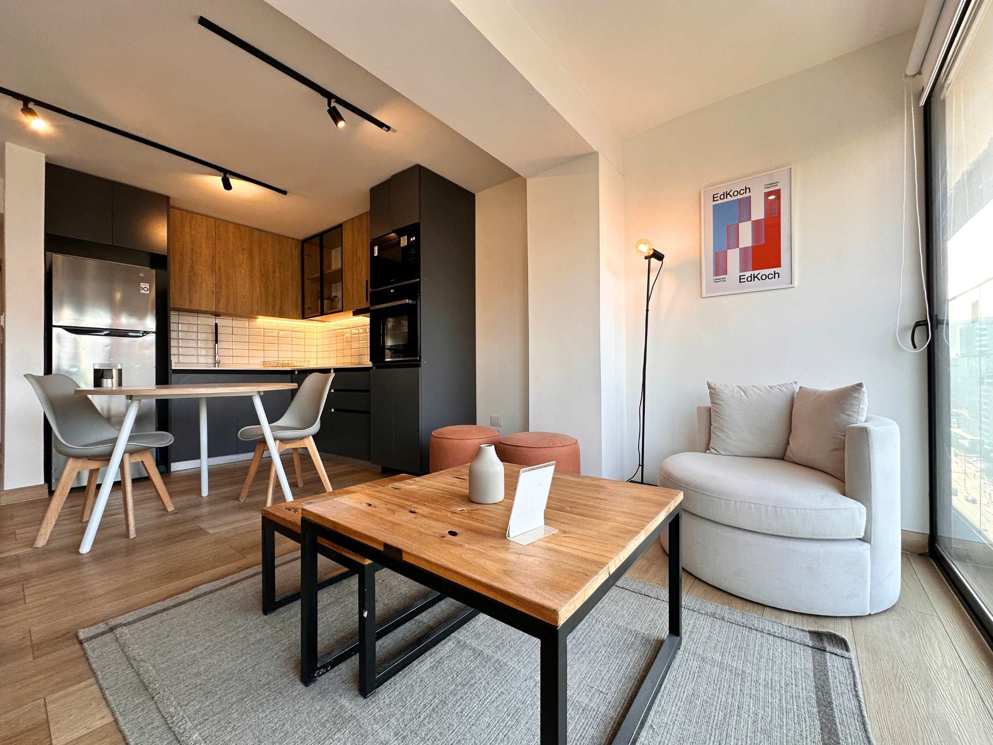 Chic studio with modern kitchen and cozy seating, perfect for a relaxing stay in the heart of the city.