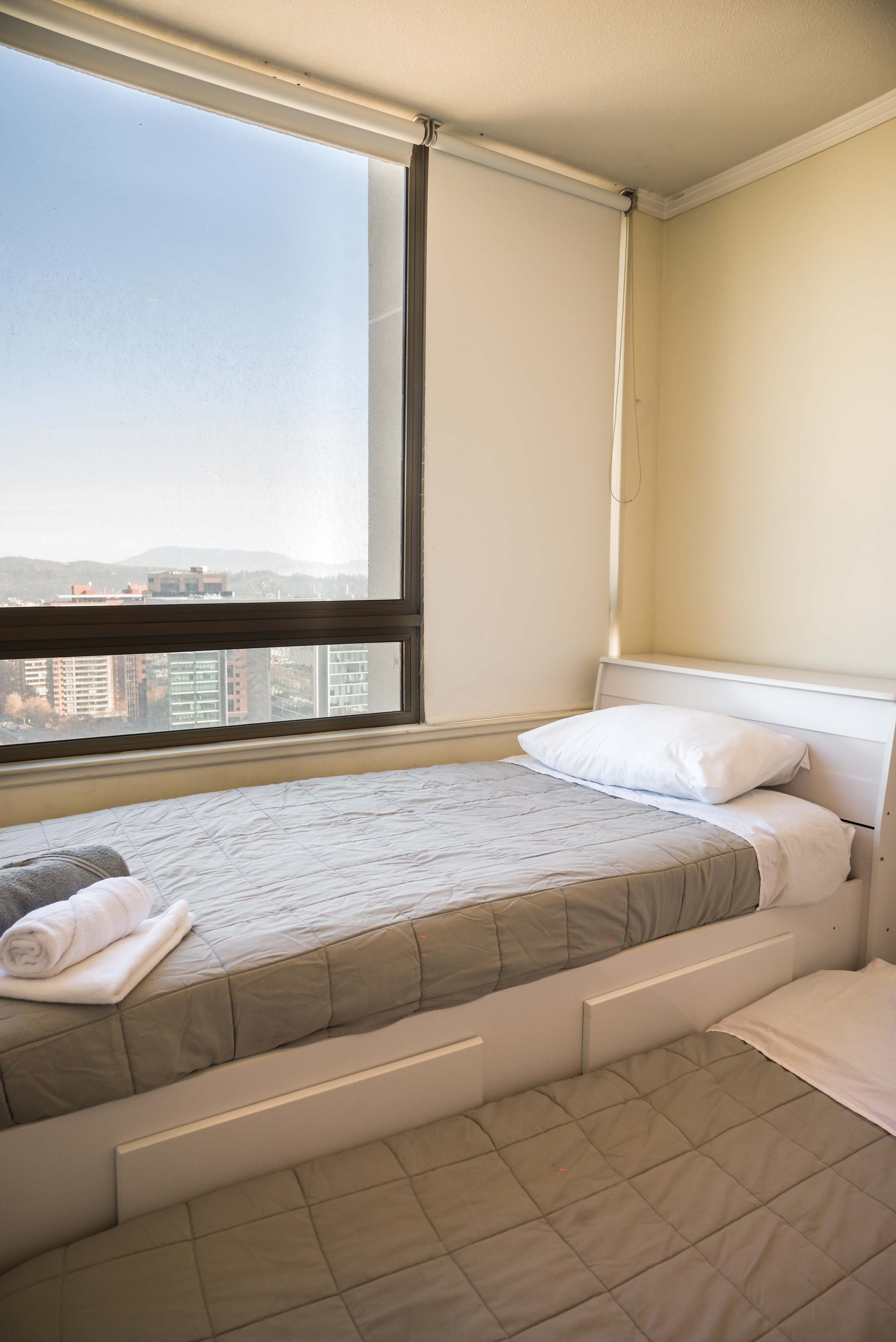 Cozy bedroom with stunning city views, perfect for a restful stay in the heart of Chile.