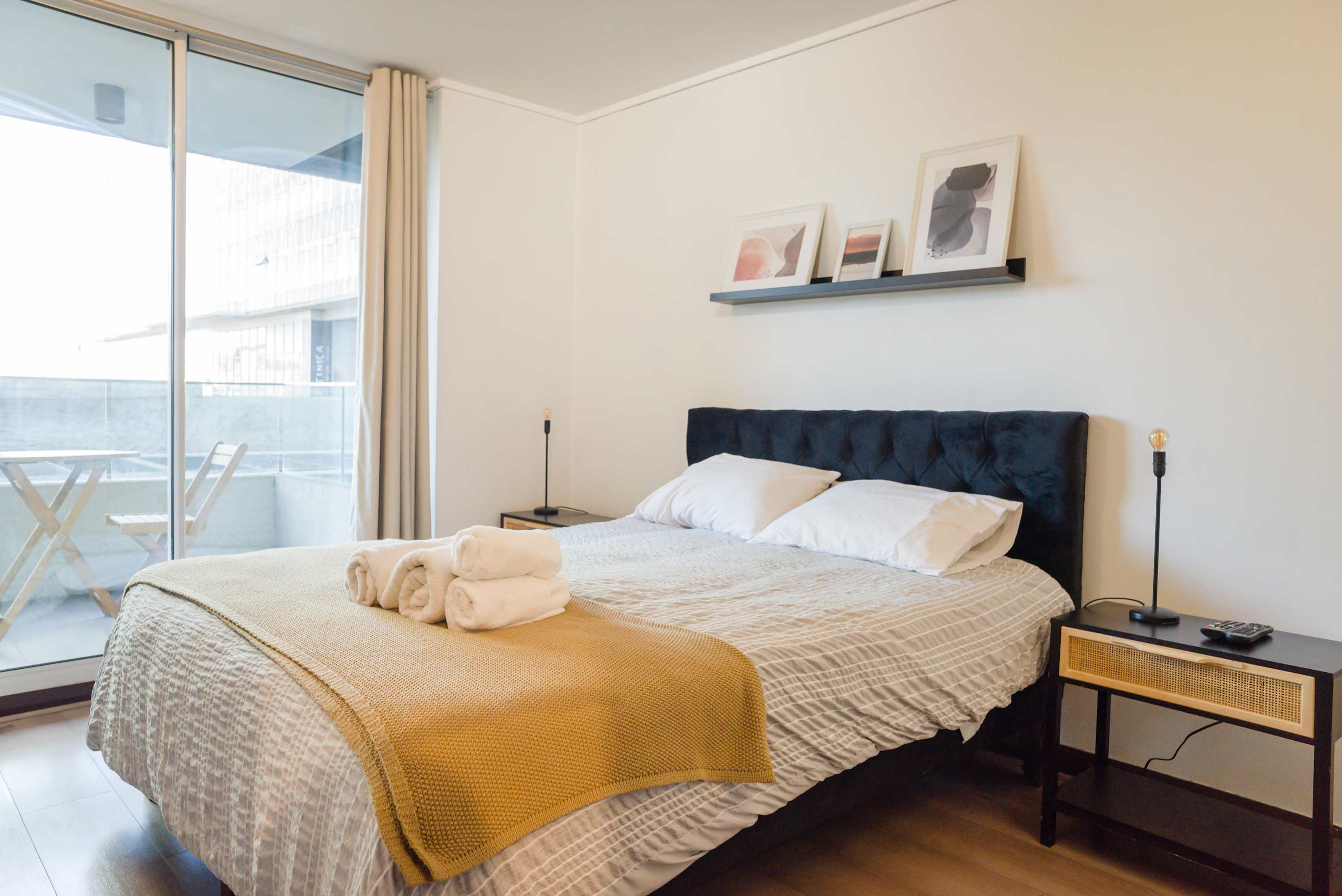 Relax in this bright and cozy bedroom with balcony access, perfect for unwinding after a day exploring the city.