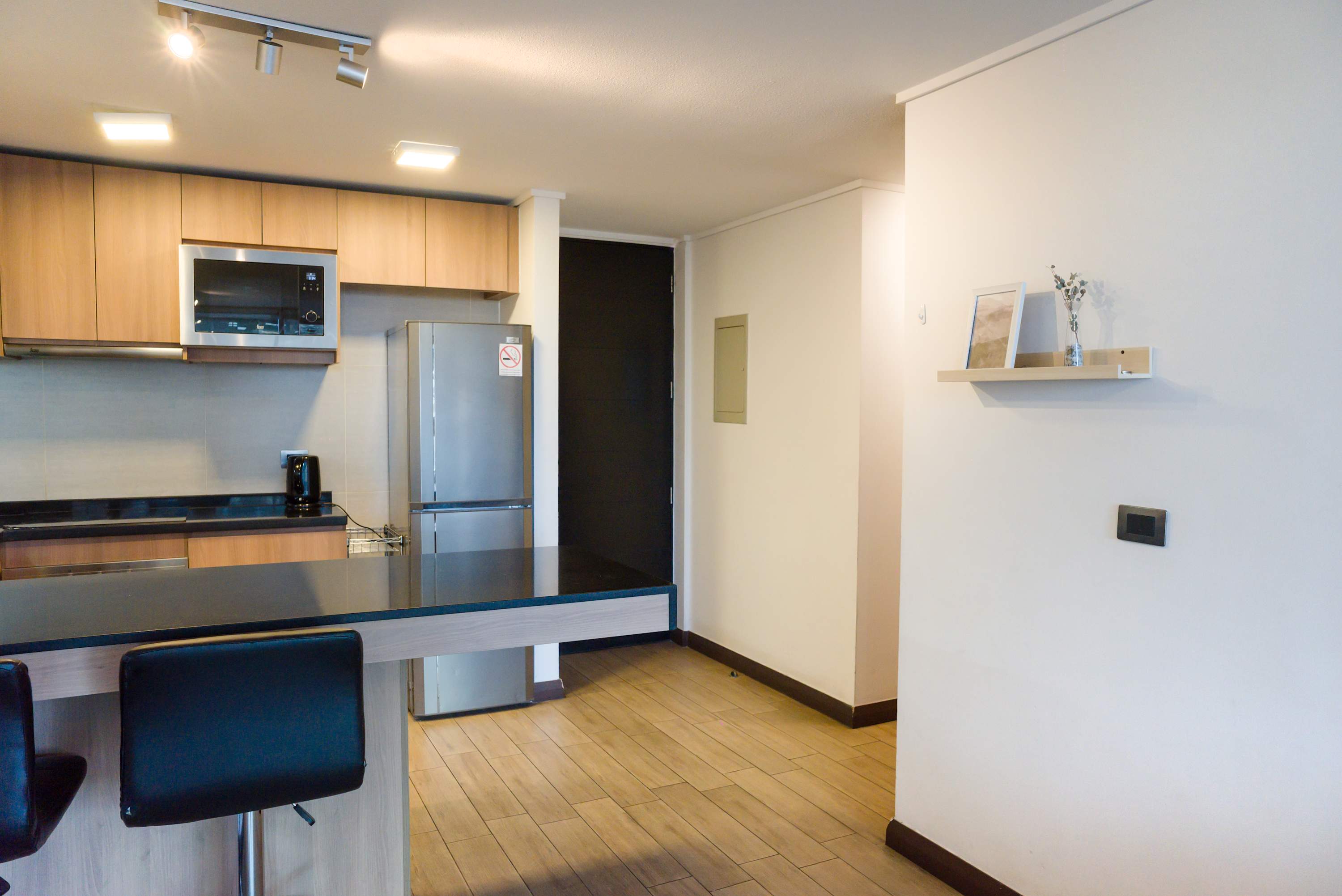 Sleek and modern kitchen with stainless steel appliances and a cozy breakfast bar, perfect for enjoying a morning coffee.