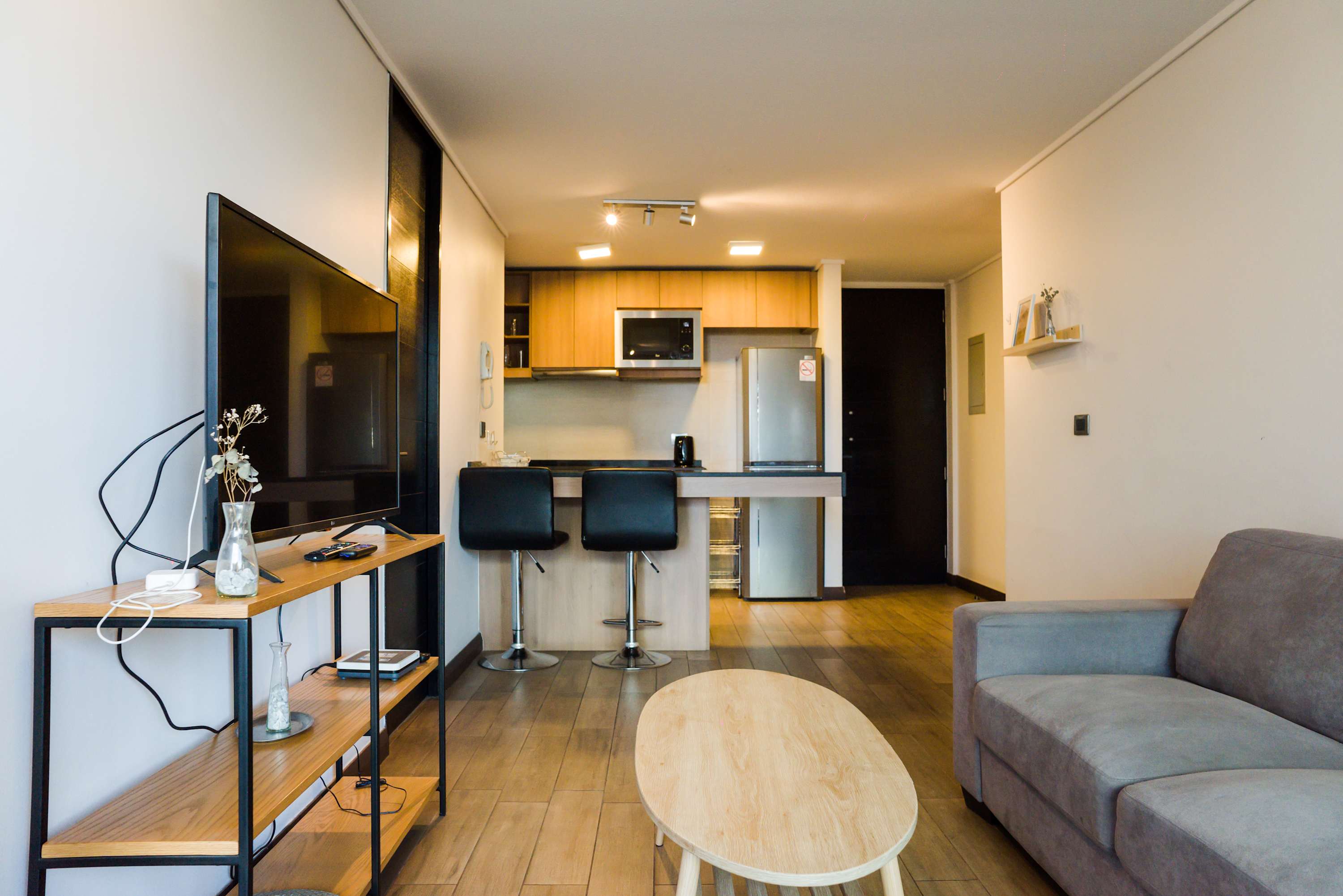 Relax in this cozy living space with modern amenities and a fully equipped kitchen, perfect for unwinding after a day of exploring.