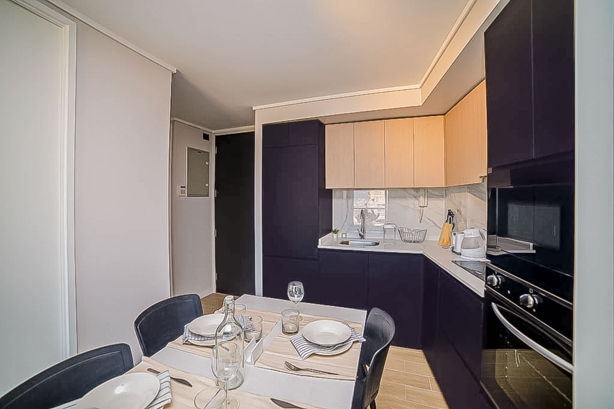 Modern kitchen with sleek design and cozy dining area, perfect for intimate meals in your private retreat.