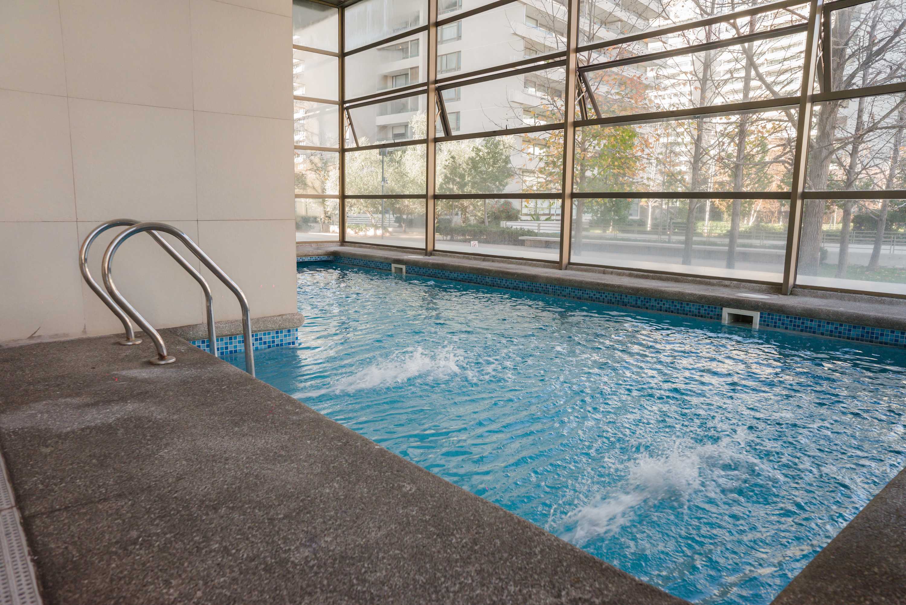 Relax and unwind in this serene indoor pool with stunning views of the surrounding greenery.