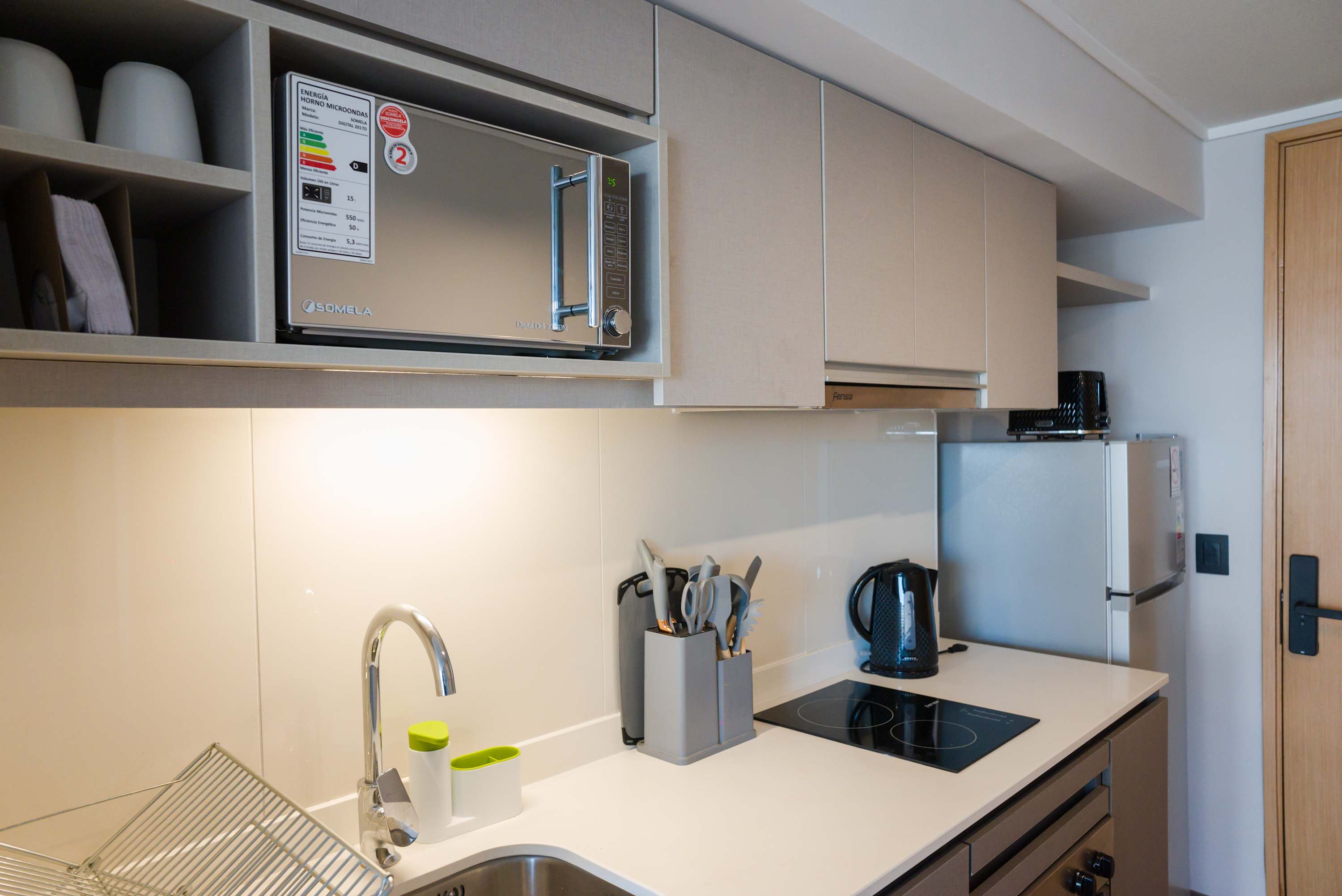 Compact and modern kitchen with all essentials for a delightful stay in Chile's vibrant heart.