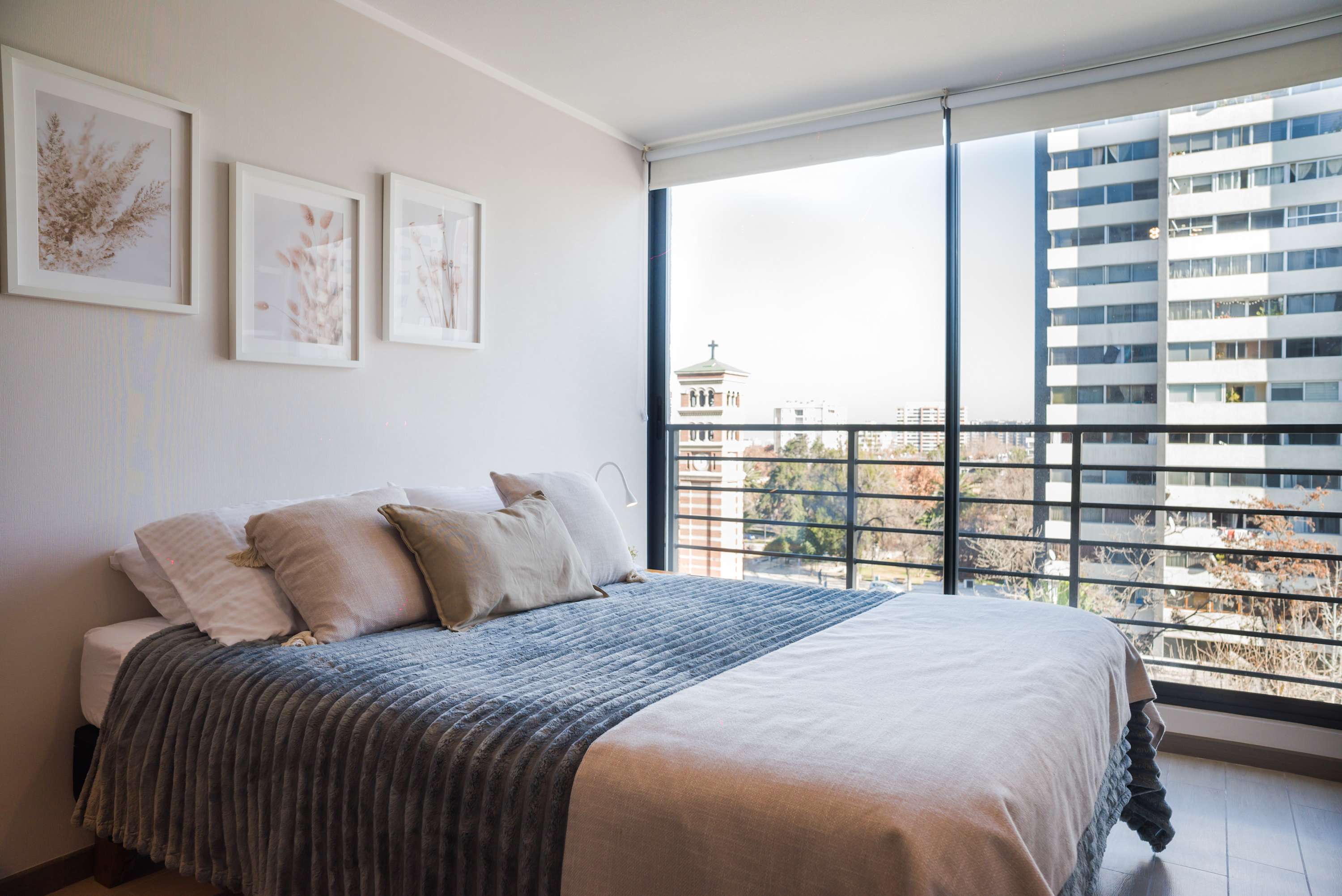 Relax in this cozy bedroom with stunning city views and abundant natural light, perfect for a serene getaway.