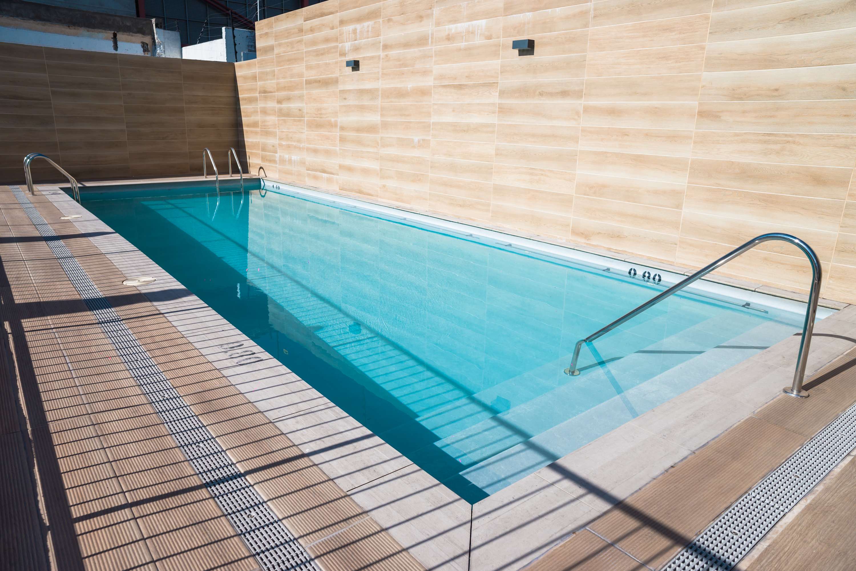 Enjoy a refreshing dip in this modern pool, perfect for relaxation and sunbathing. (Common Area)