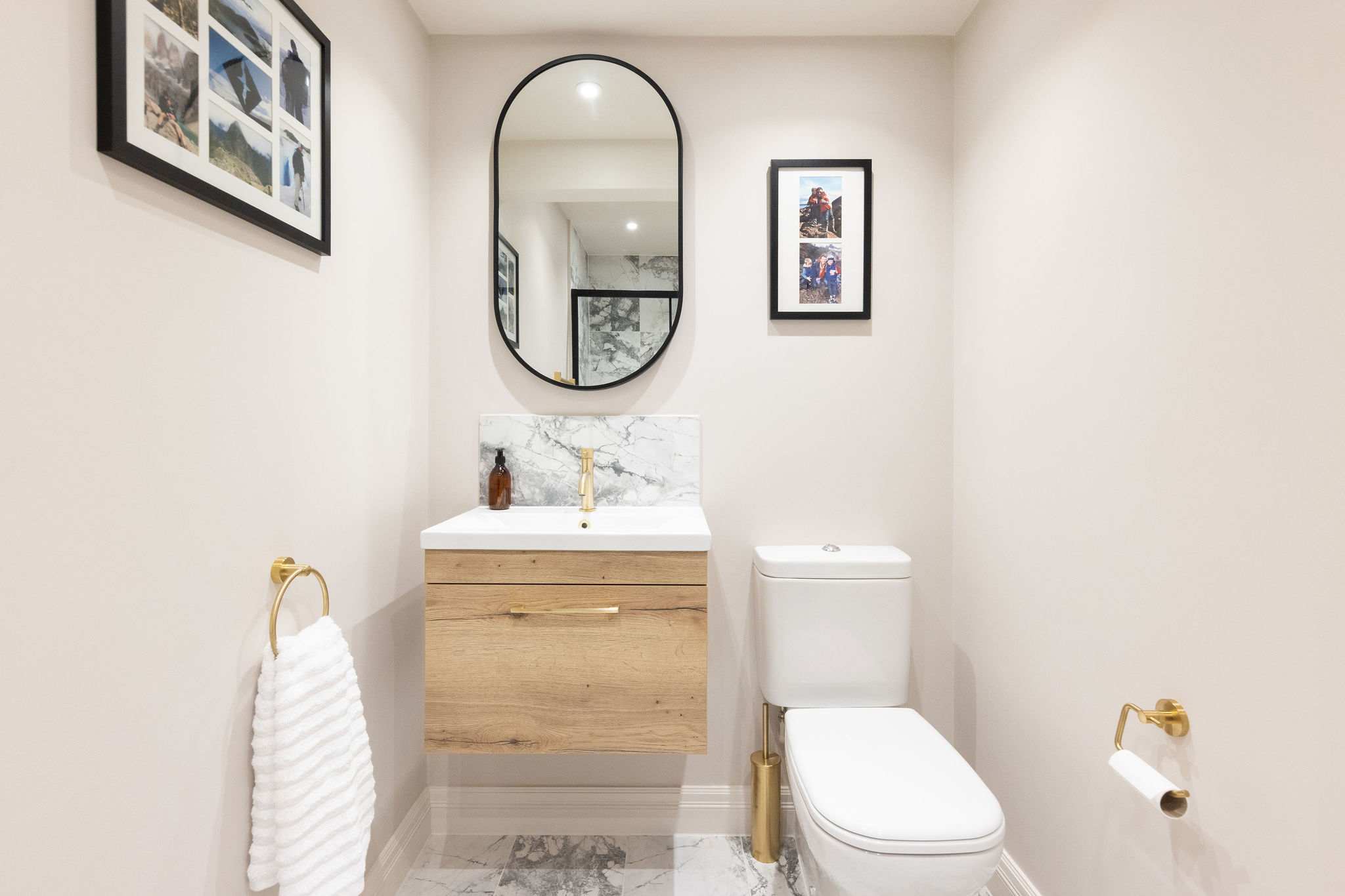 Modern downstairs WC with gold and marble accents
