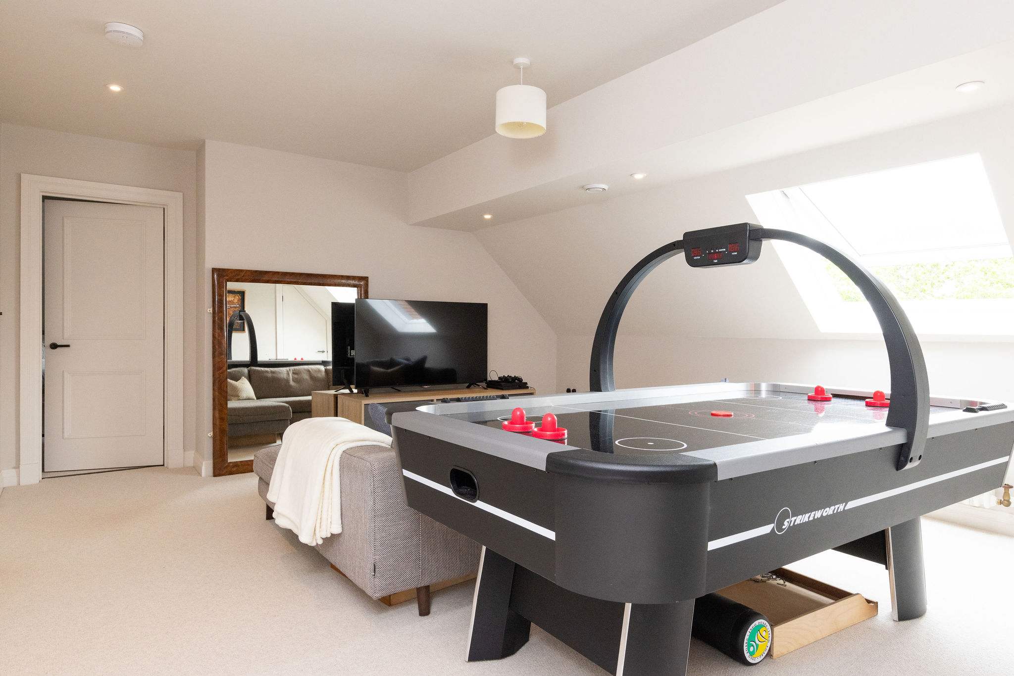 Spacious games room with air hockey, lounge area w Playstation