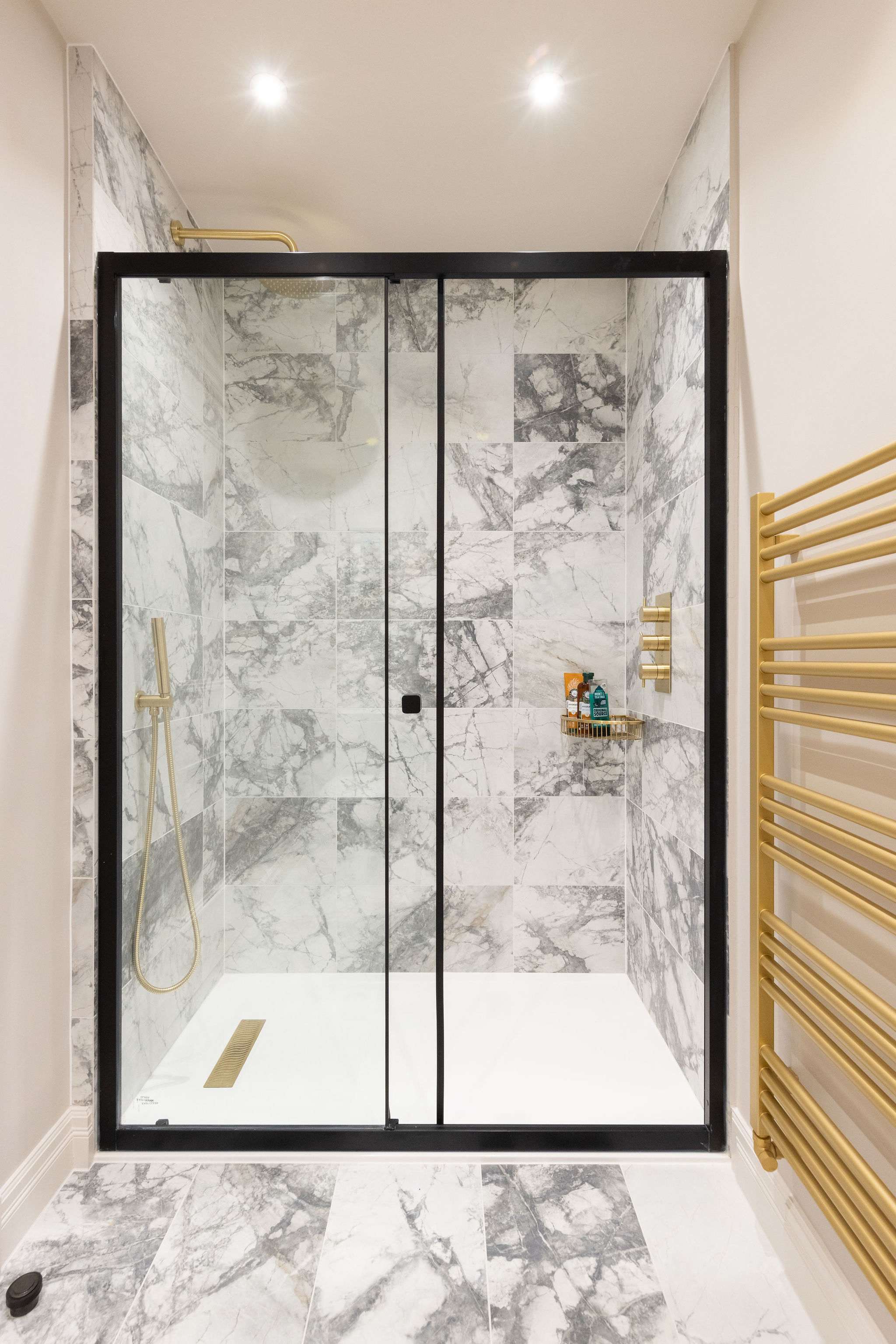 Sleek walk-in shower with luxury marble tiles