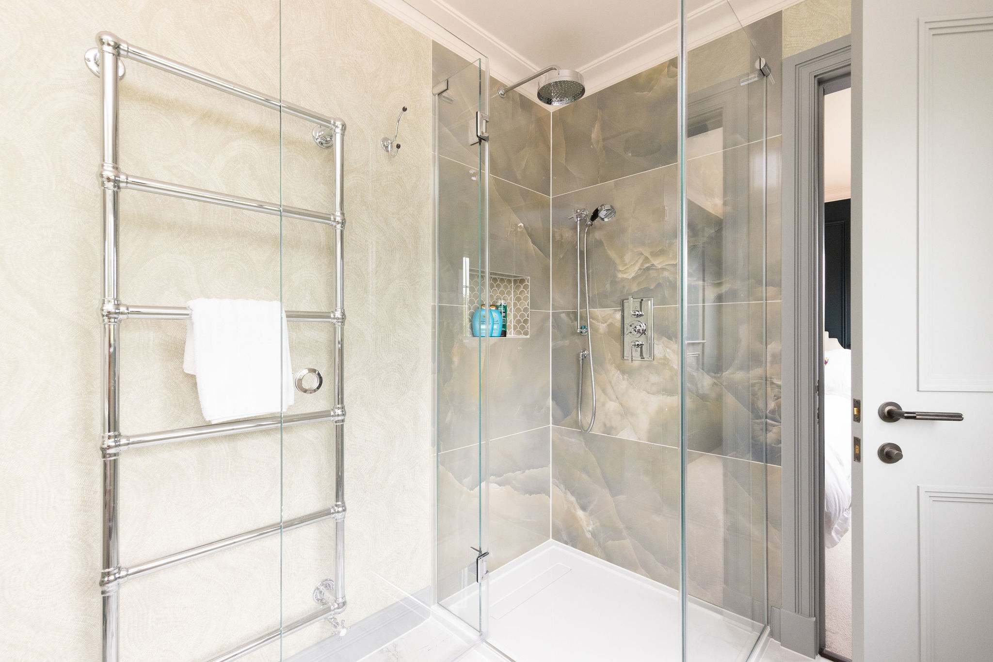 Modern shower with rainfall head and stone-effect tiles