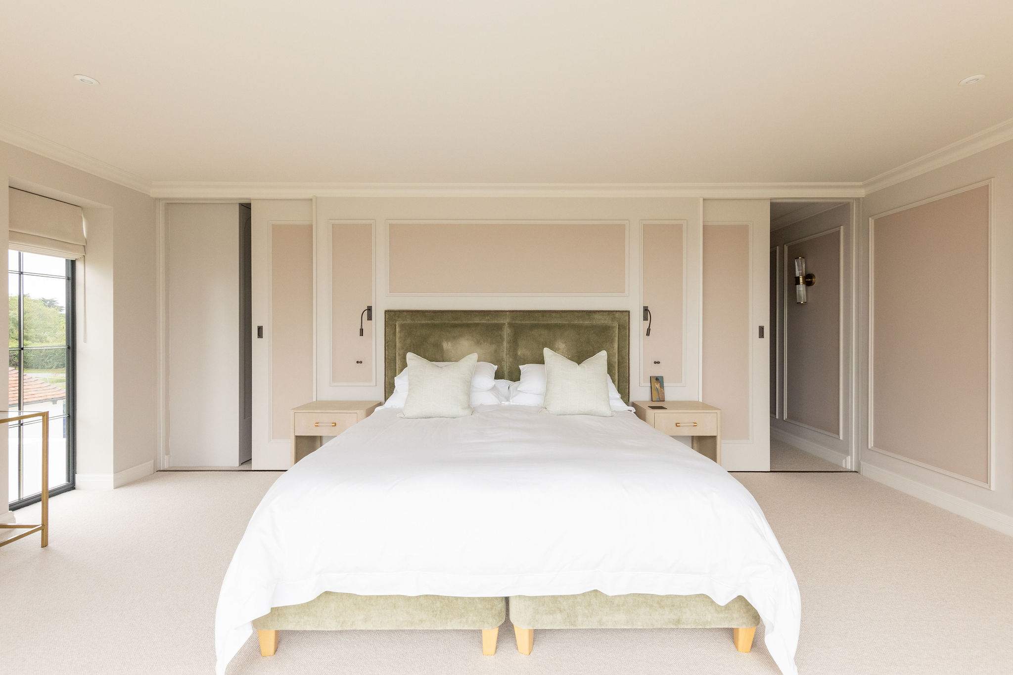 Elegant principal suite with super king bed, soft neutral tones, and balcony access