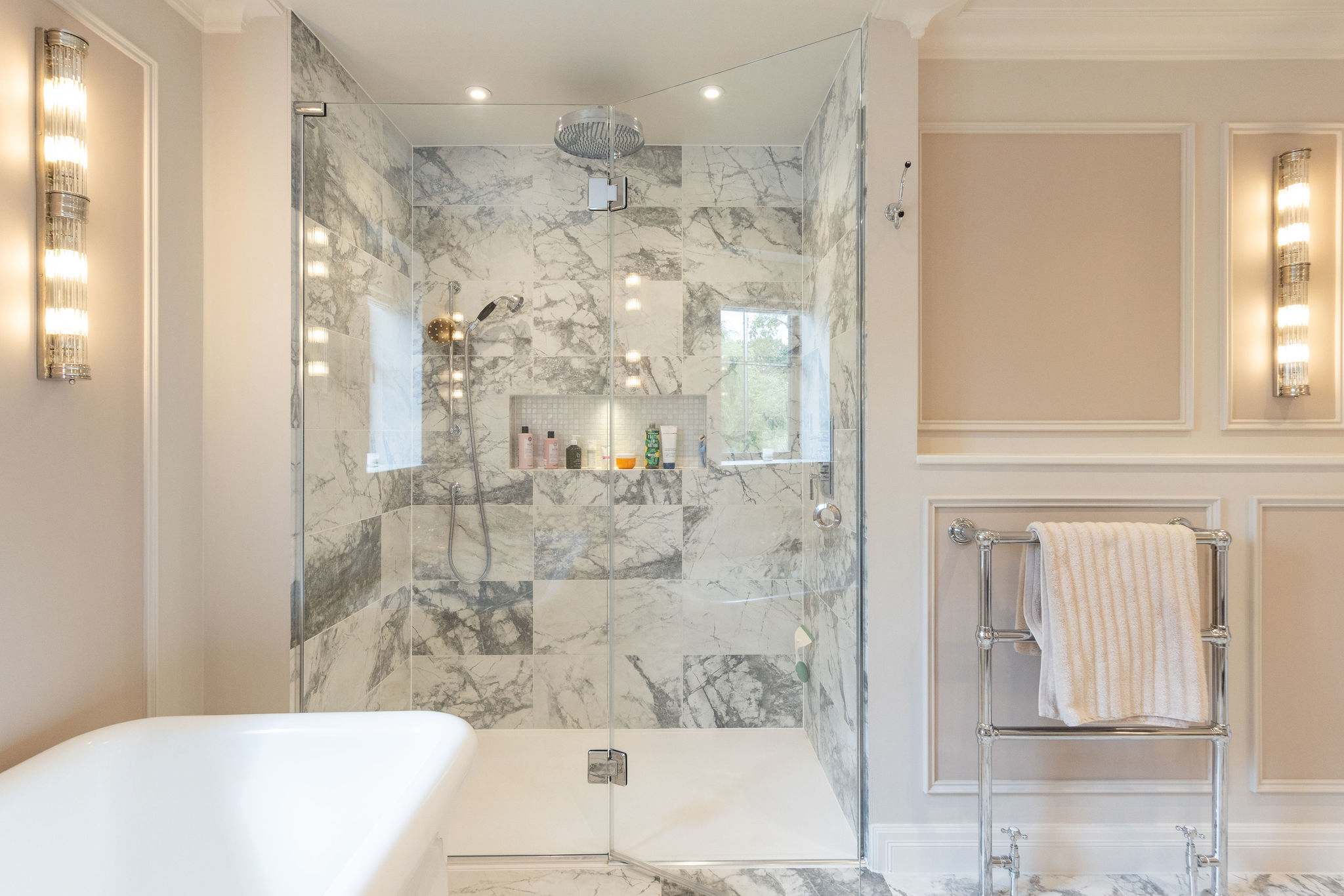 Spacious rainfall shower with luxury marble finish and premium fittings