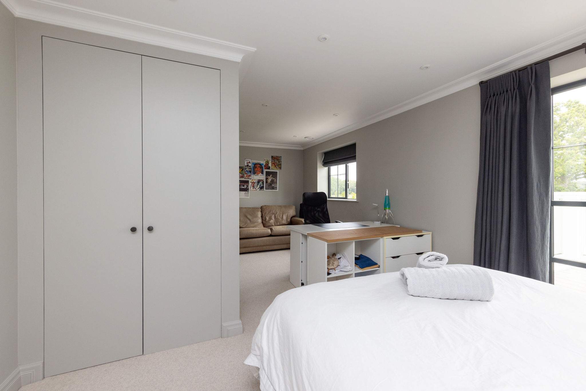 Spacious bedroom with desk and sofa bed