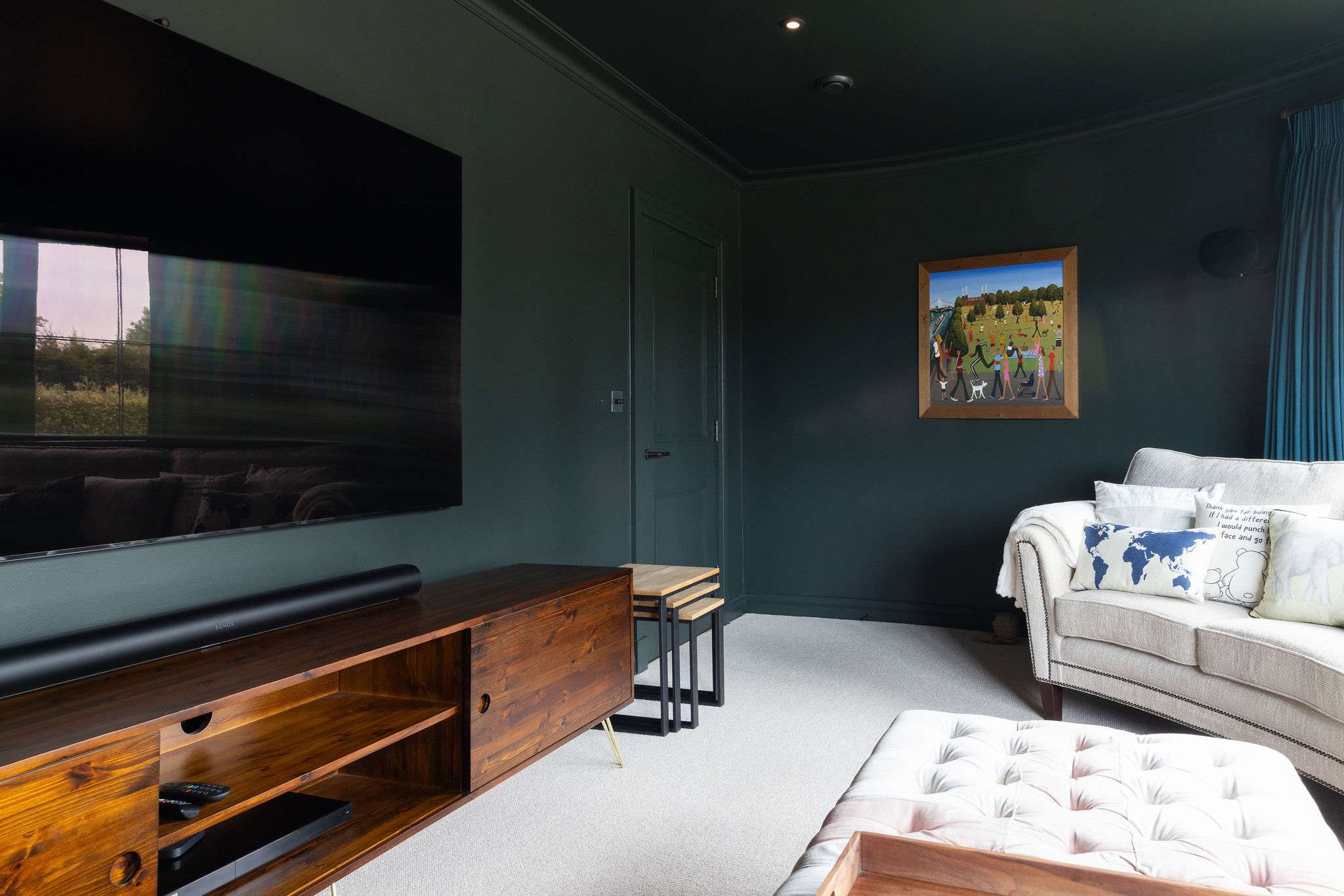 Stylish cinema room with plush seating, and a huge flat-screen – perfect for movie nights.