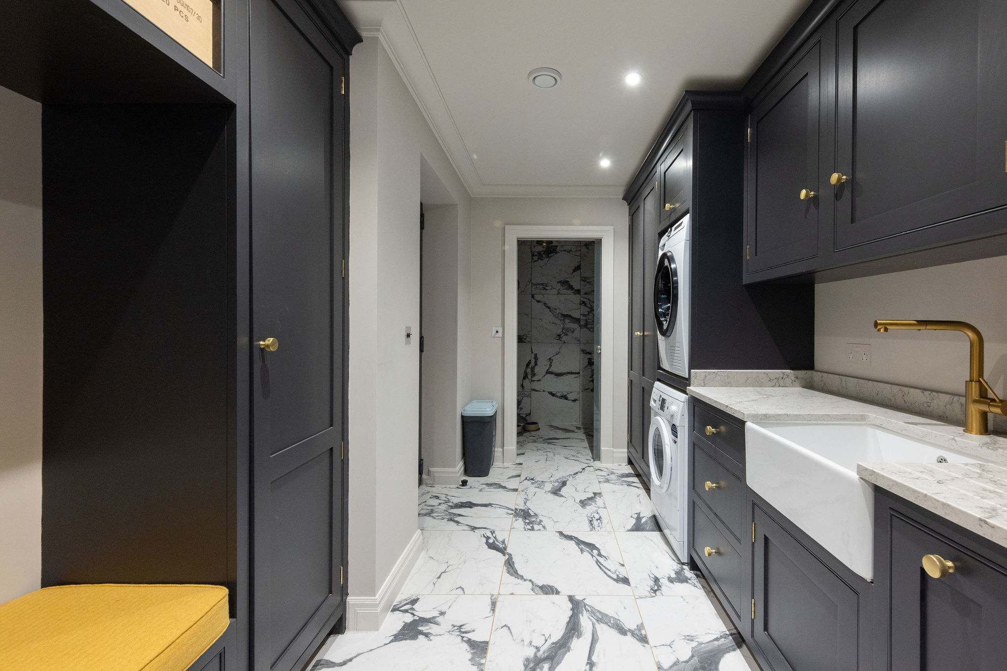 Well-equipped utility space with washer, dryer, and marble-effect flooring – ideal for extended stays