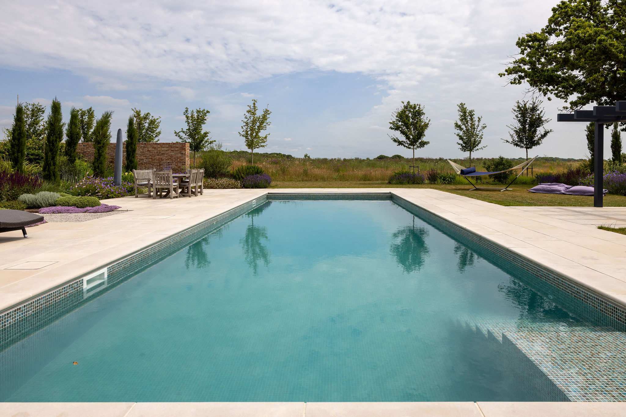 Take a dip in the heated pool surrounded by wildflower meadows and beautifully landscaped gardens