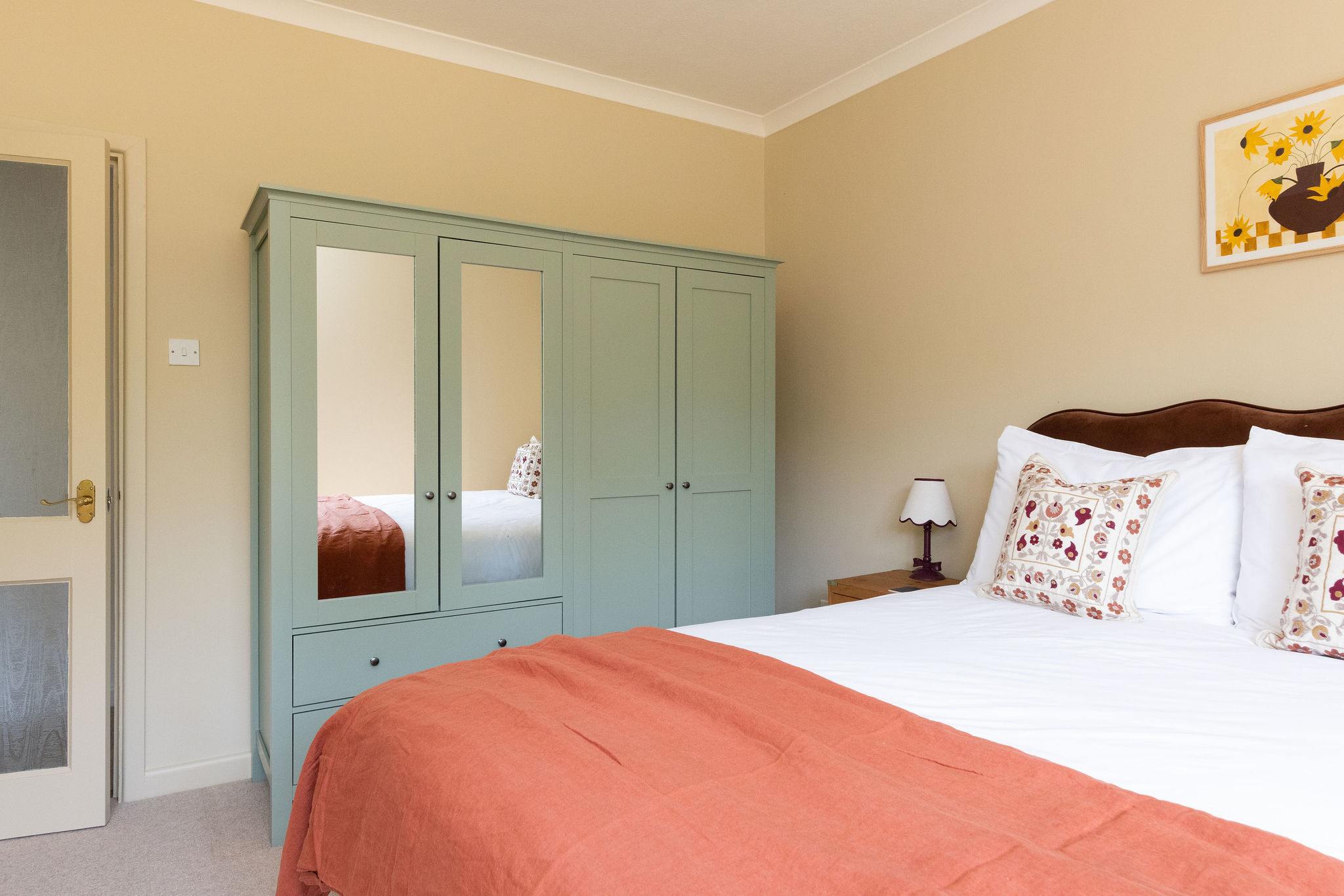 The king room has plenty of wardrobe and draw space, as well as side tables and reading lamps.