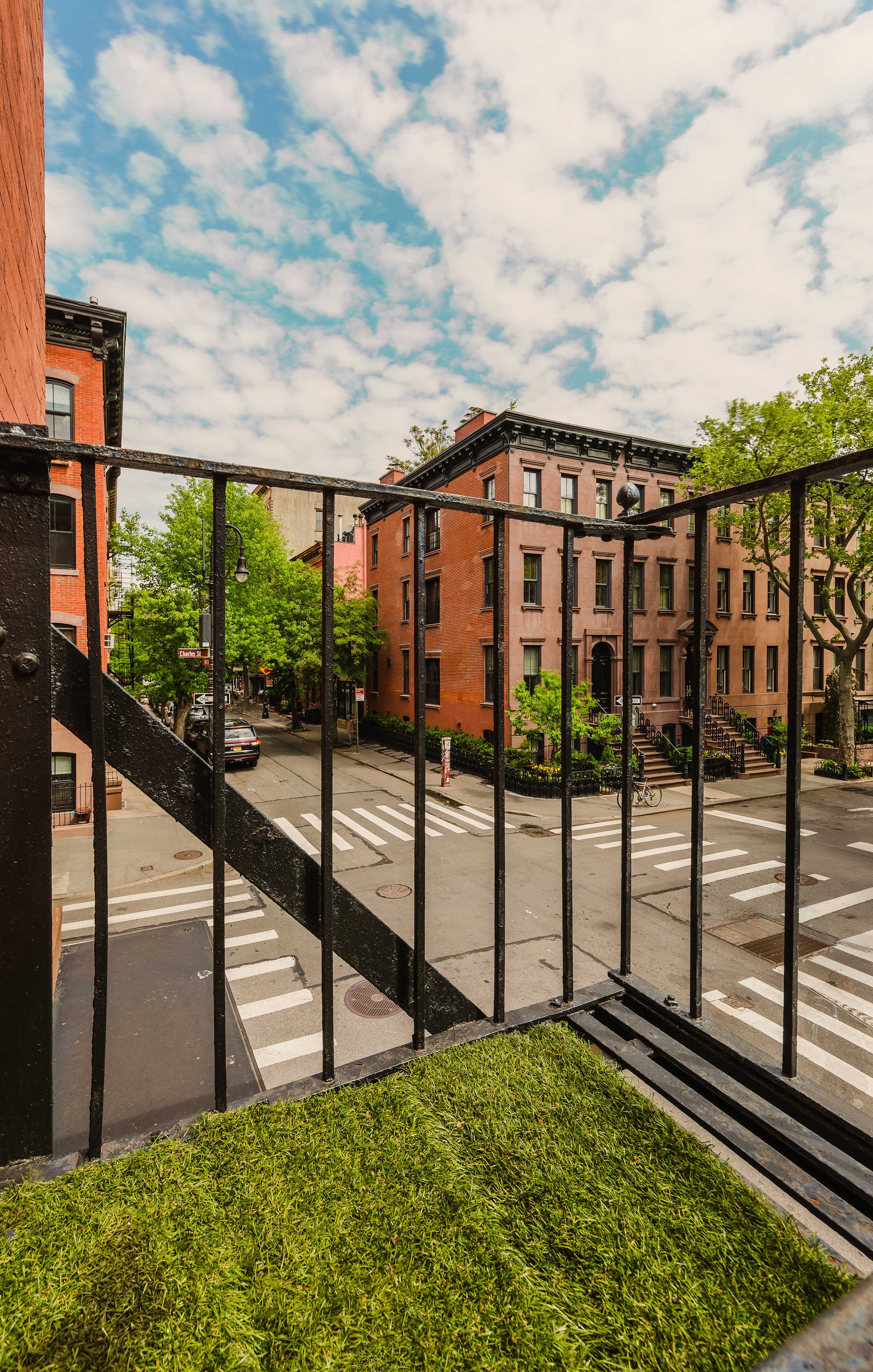 View from the Juliet balcony over the tree-lined West Village street below.