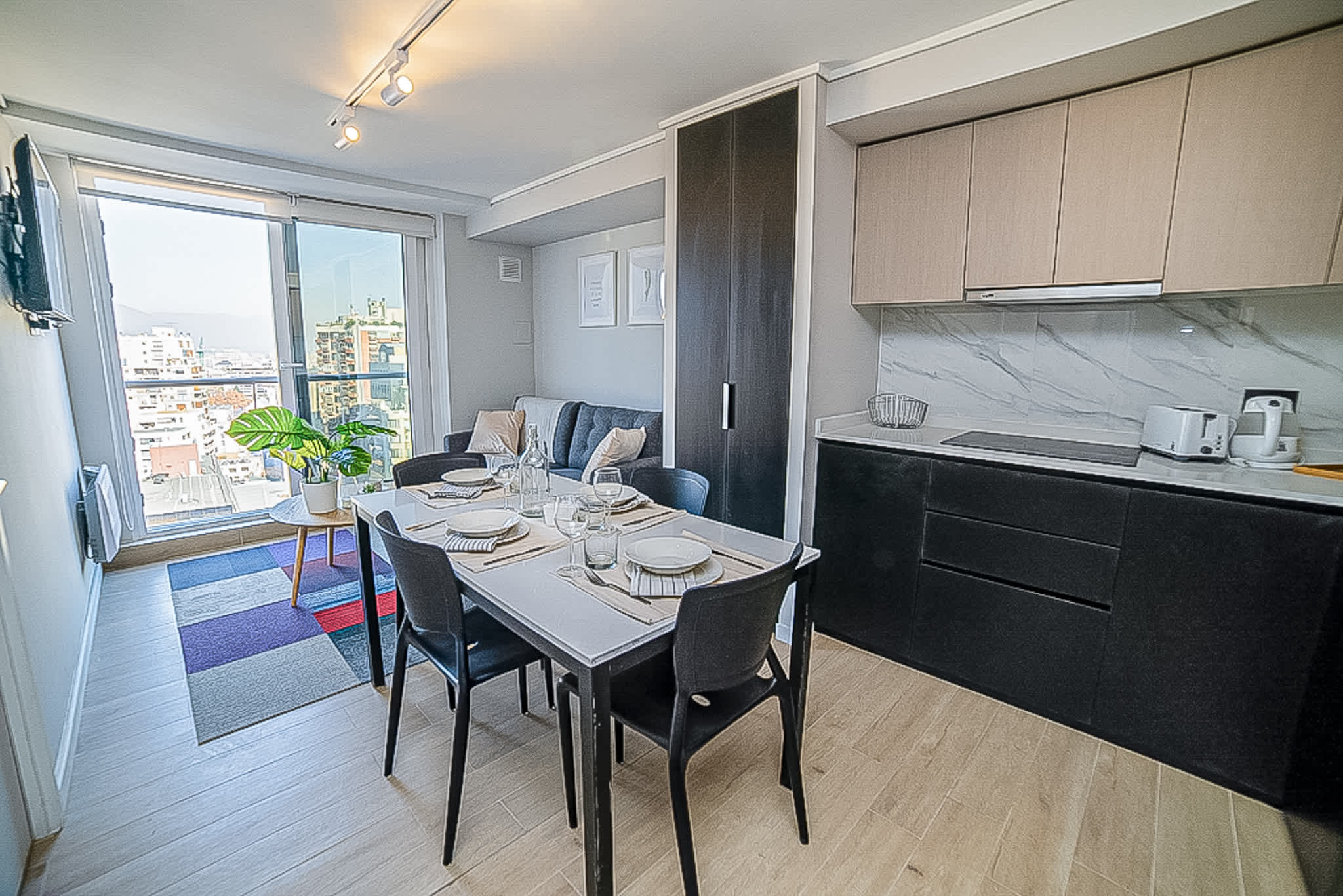 Experience urban living with stunning city views in this chic studio apartment, perfect for a cozy getaway in Chile.