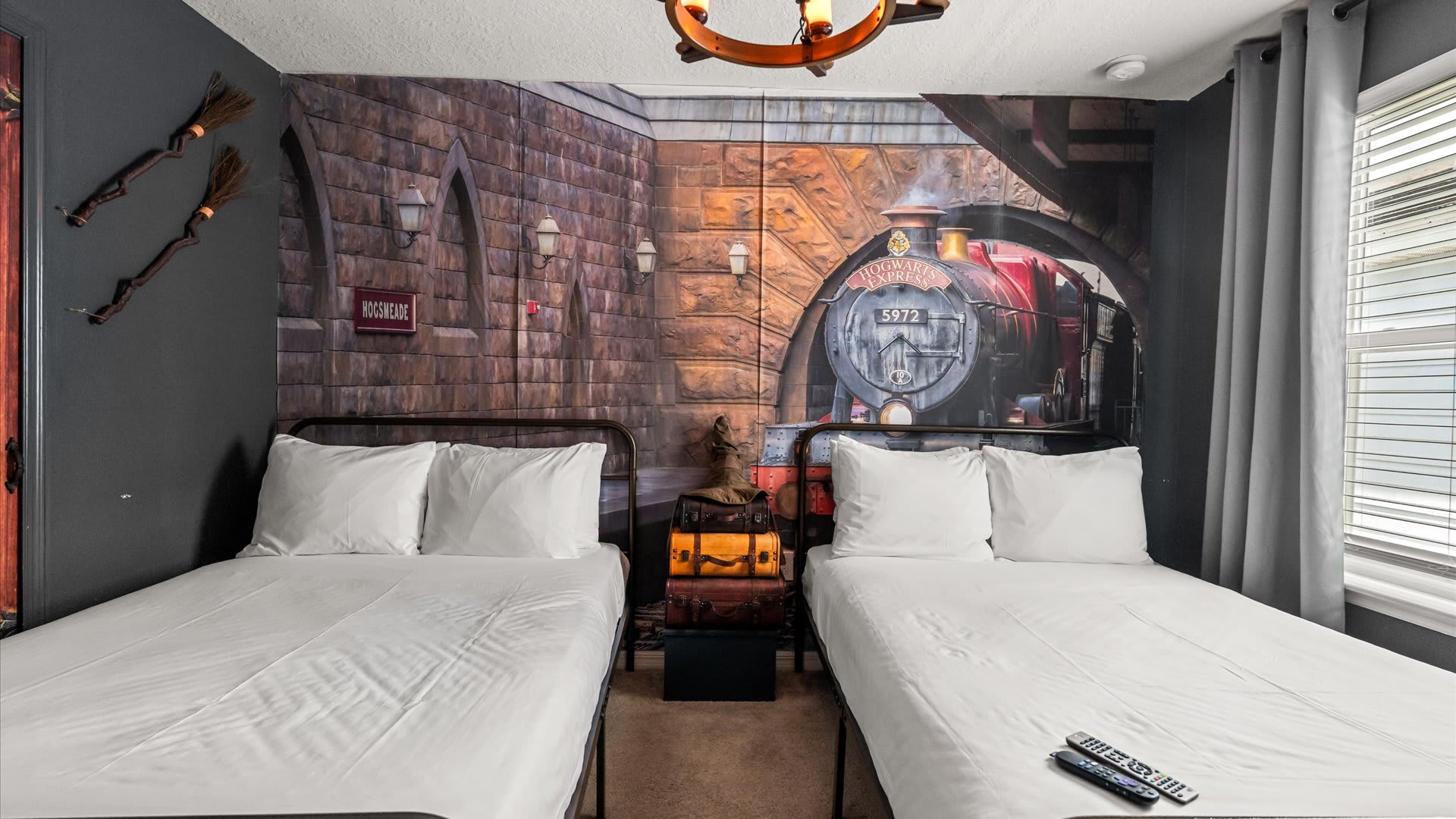 Hogwarts Themed Bedroom with Twin Double Beds | Each bedroom brings a beloved story to life with custom murals, themed décor, and comfy bedding. A magical space for kids (and kids-at-heart) to dream big.