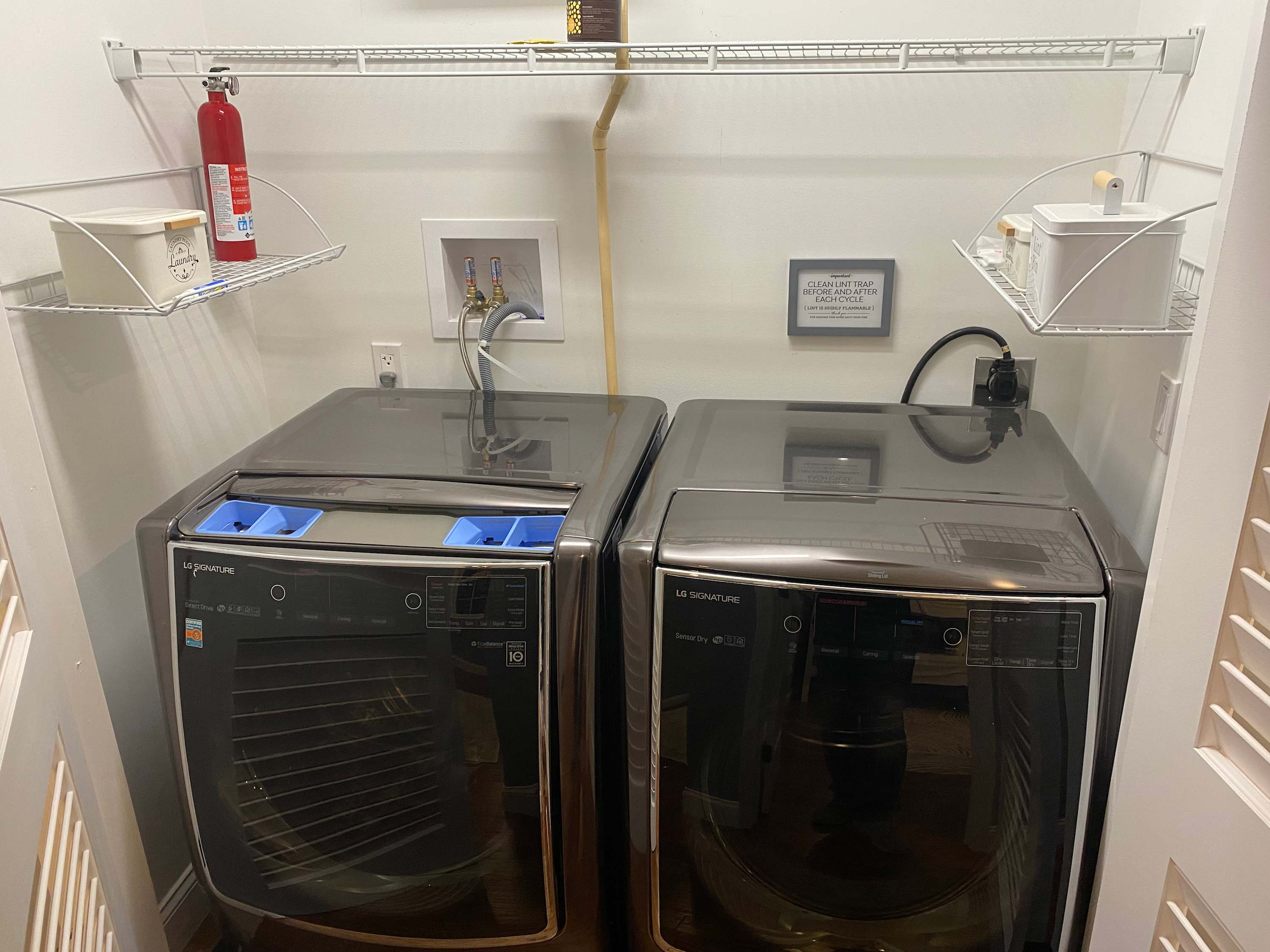 Utility Room with Full-Size Washer and Dryer for Guest Convenience