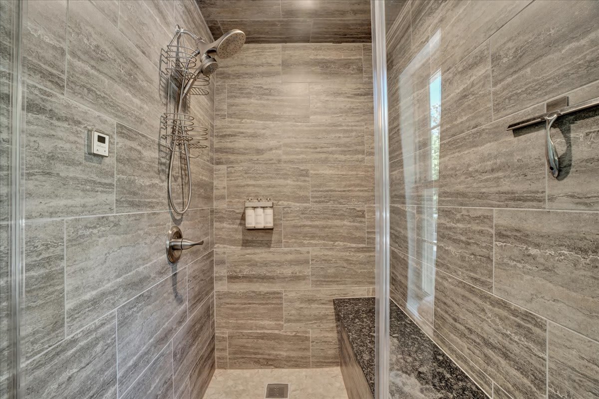 Luxurious Spa-Style Bathroom with Natural Stone Shower and Cedar Wood Accents