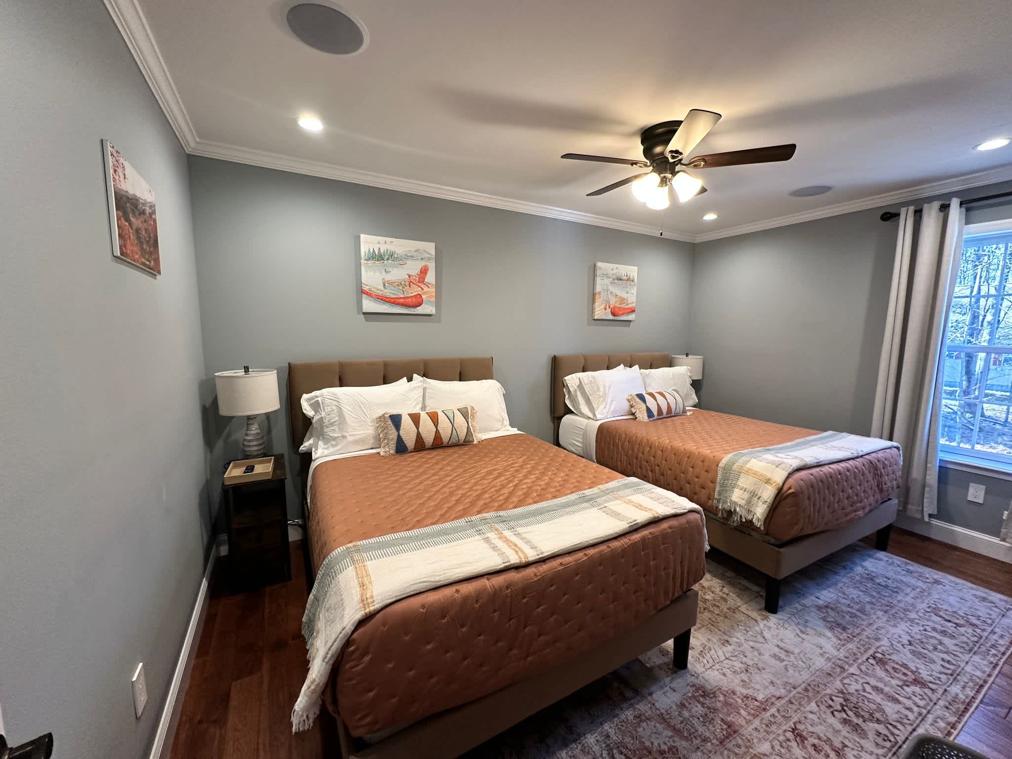 Cozy Double Bedroom with Twin Beds and Warm Wood Beam Ceiling