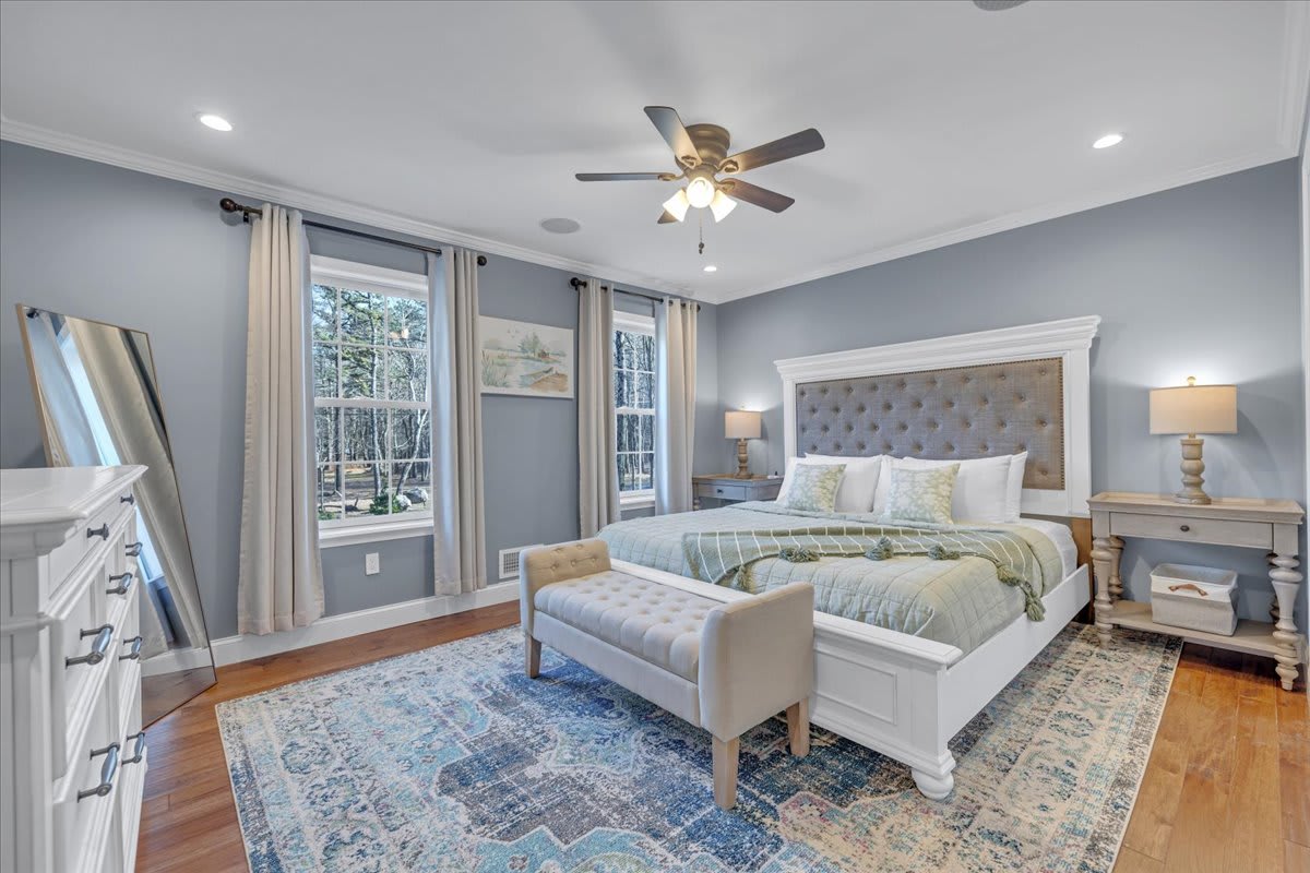 Bright King Bedroom with Floor-to-Ceiling Windows and Ceiling Fan
